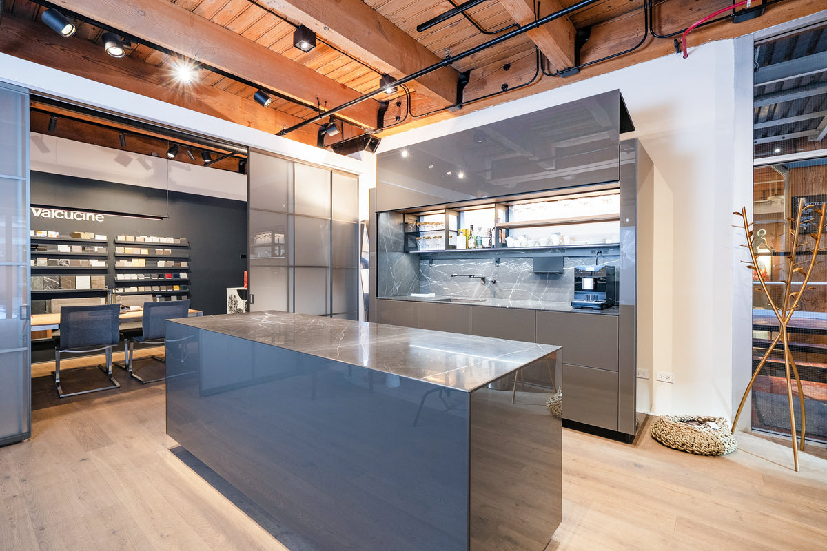 Luxury wet bar cabinets and kitchen island with integrated storage in a modern showroom