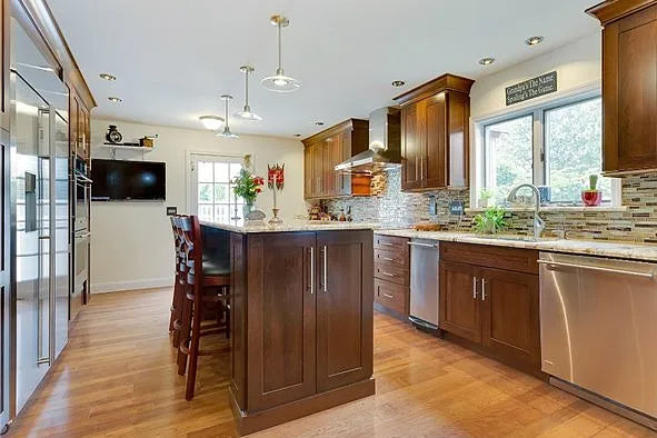Kraftmaid Transitional Dark Wooden Kitchen with Marble Countertops and GE Monogram Appliances