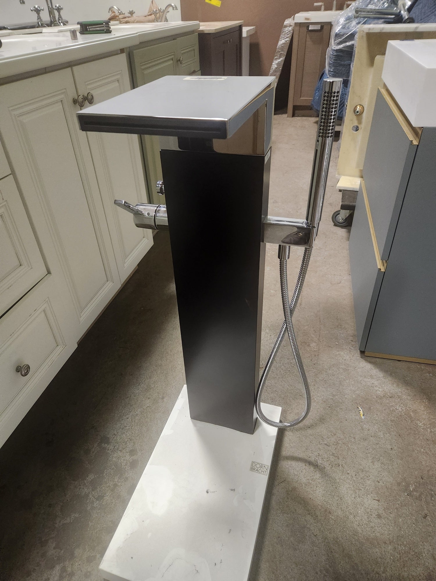 Close up detail of the polished chrome finish and valve controls on a Dornbracht floor mount tub filler