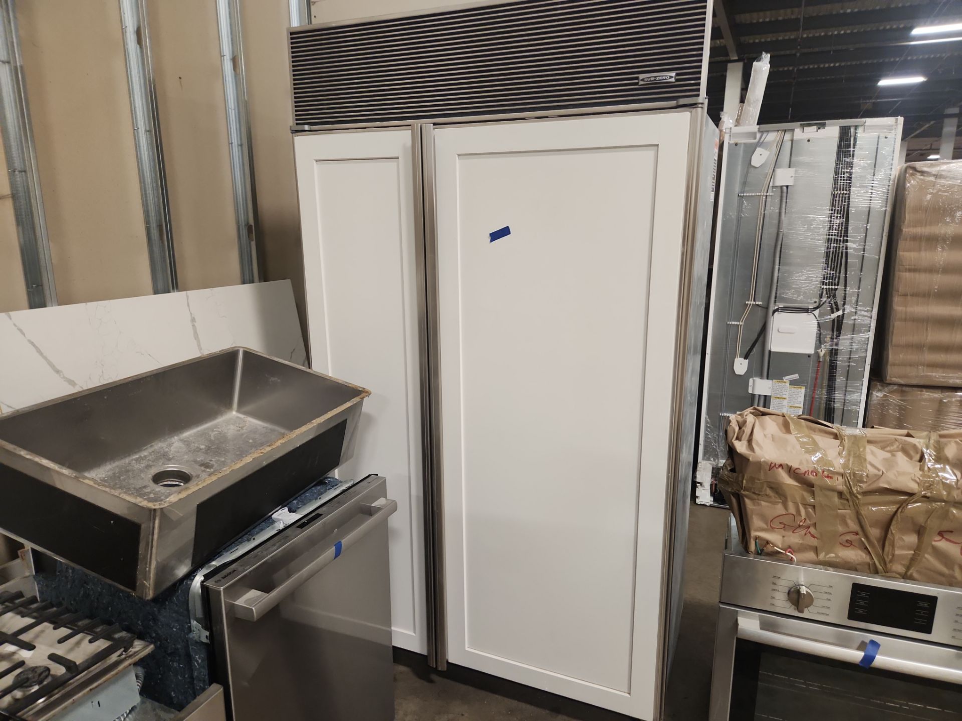 ÒThe WesterlyÓ Transitional White Kitchen with Island, 48" Sub-Zero Refrigerator and Bosch Appliances