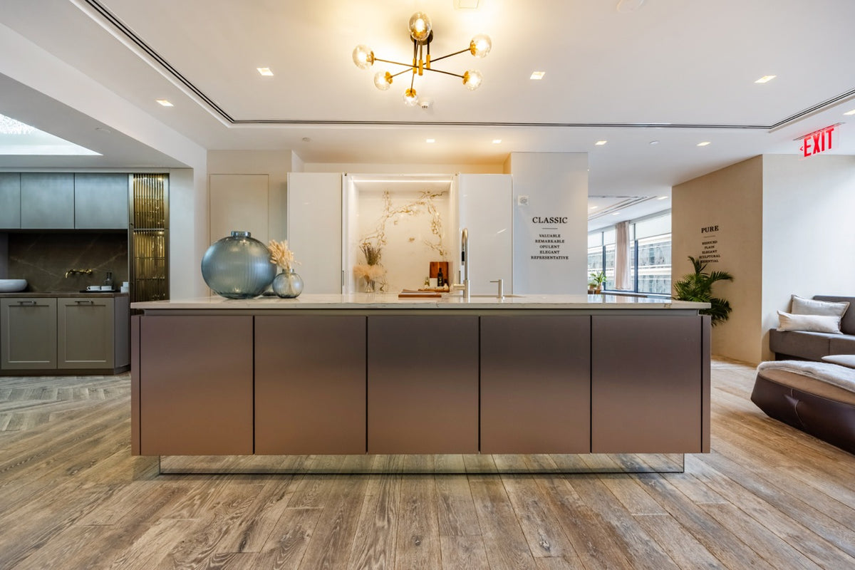 SieMatic Modern Rose Gold Handleless Island with Lotus White Hideaway Pantry with Pocket Doors