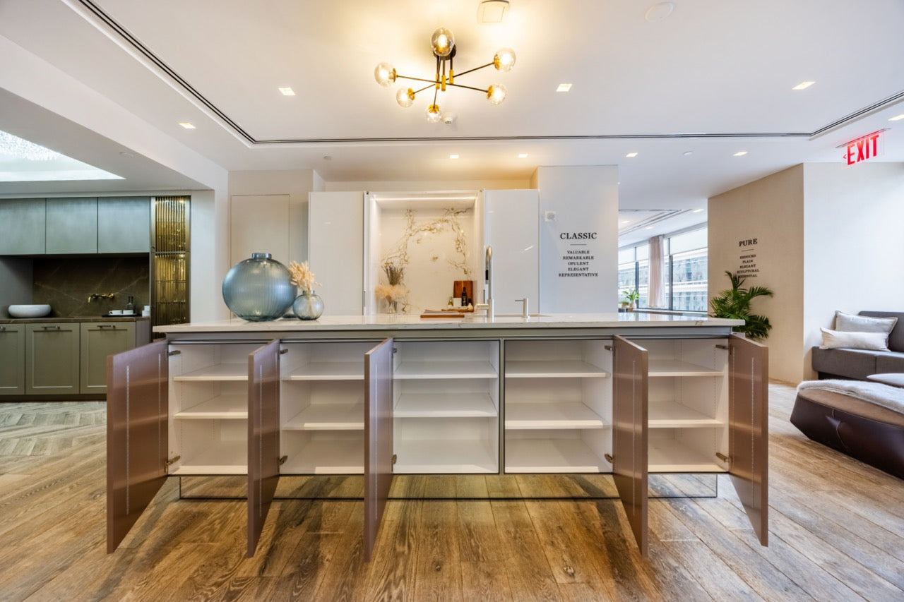 SieMatic Modern Rose Gold Handleless Island with Lotus White Hideaway Pantry with Pocket Doors