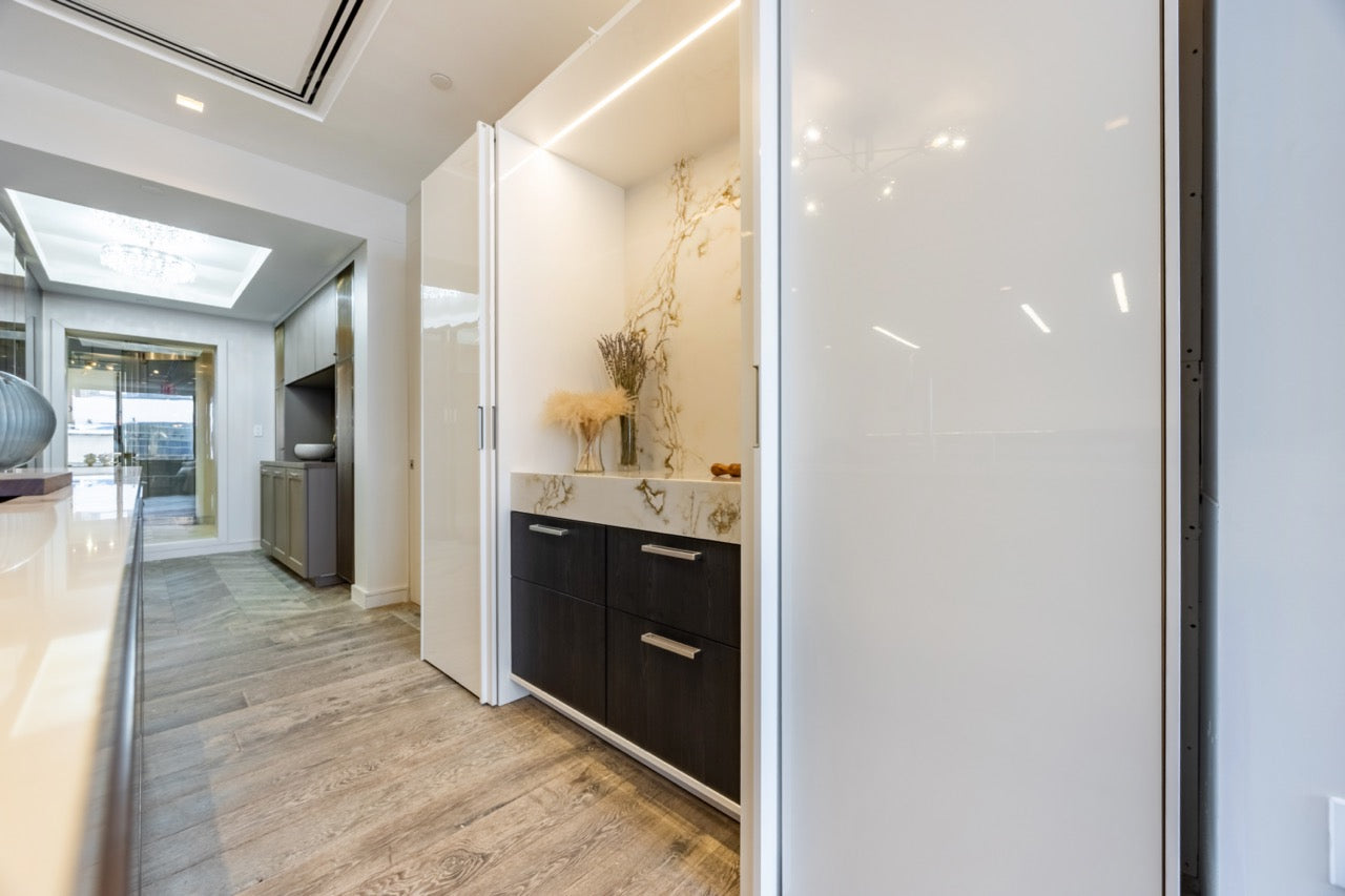 SieMatic Modern Rose Gold Handleless Island with Lotus White Hideaway Pantry with Pocket Doors