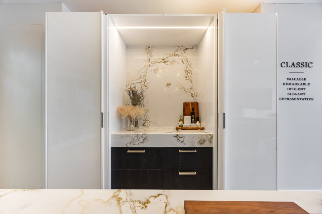 SieMatic S2 Modern Rose Gold Handleless Island with Lotus White Hideaway Pantry