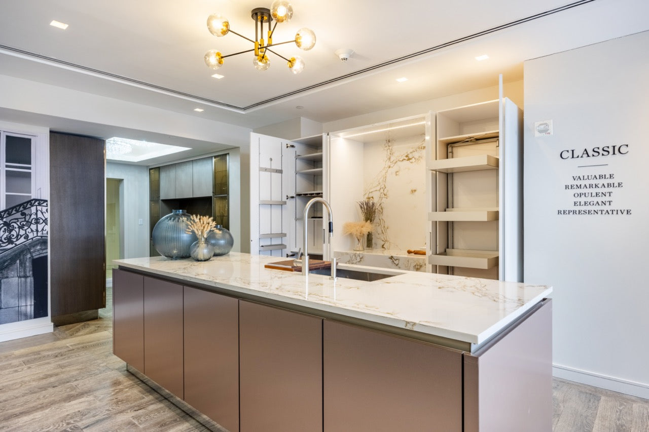 SieMatic Modern Rose Gold Handleless Island with Lotus White Hideaway Pantry with Pocket Doors