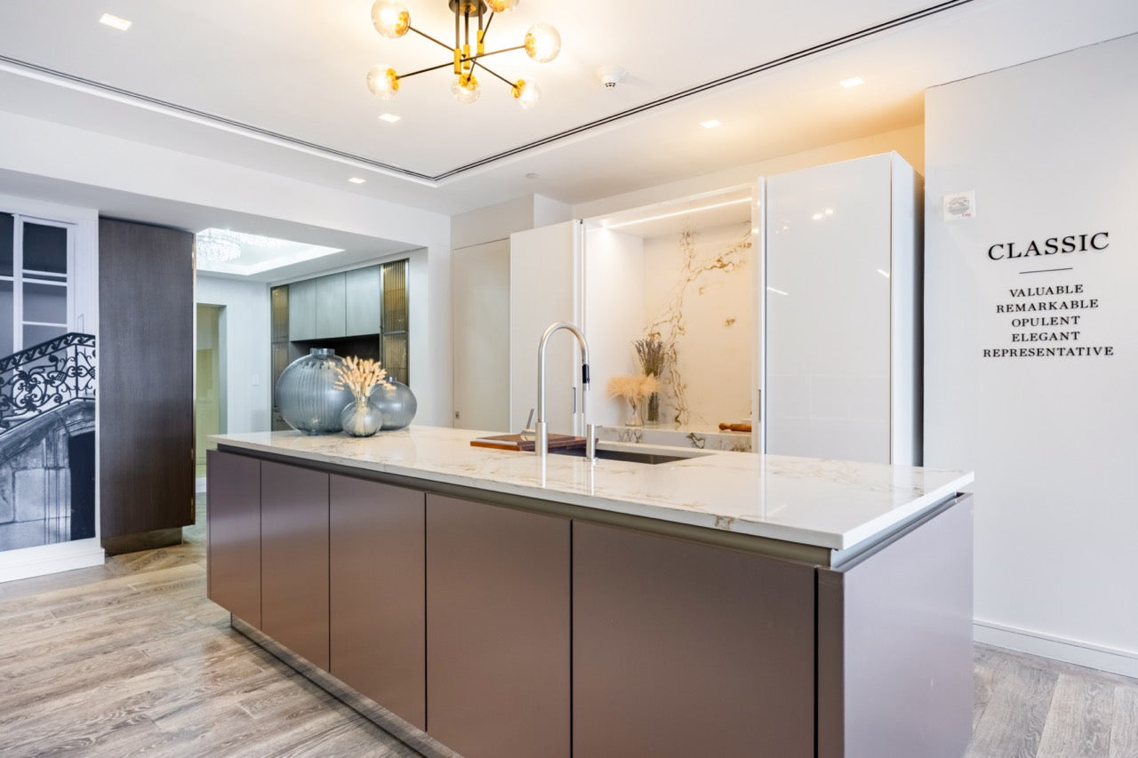 SieMatic Modern Rose Gold Handleless Island with Lotus White Hideaway Pantry with Pocket Doors