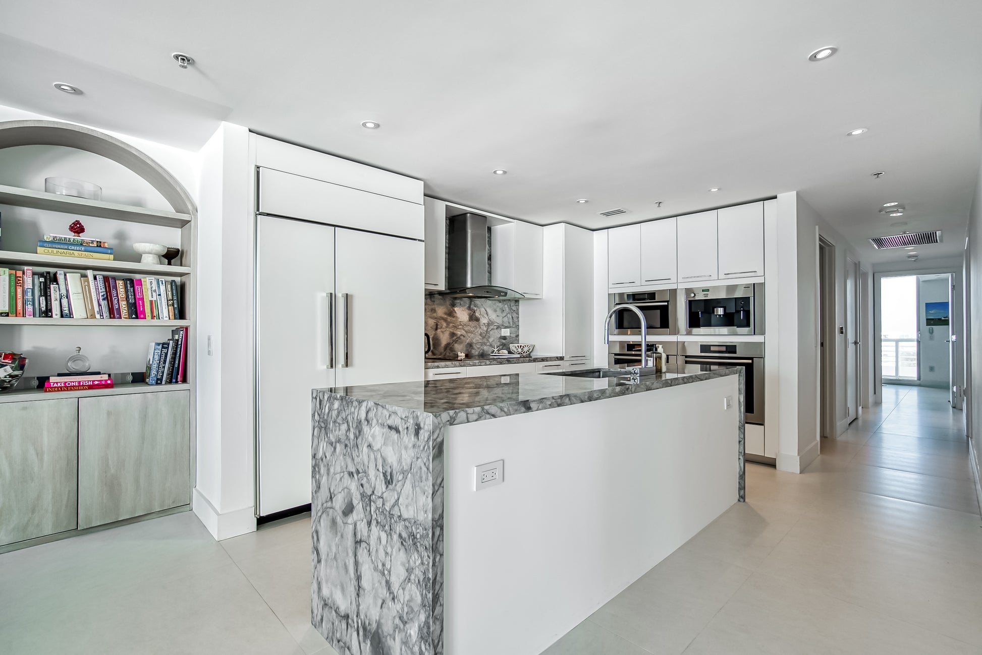 Poggenpohl White Modern Kitchen with Waterfall Island, Marble Countertops and Miele Appliances