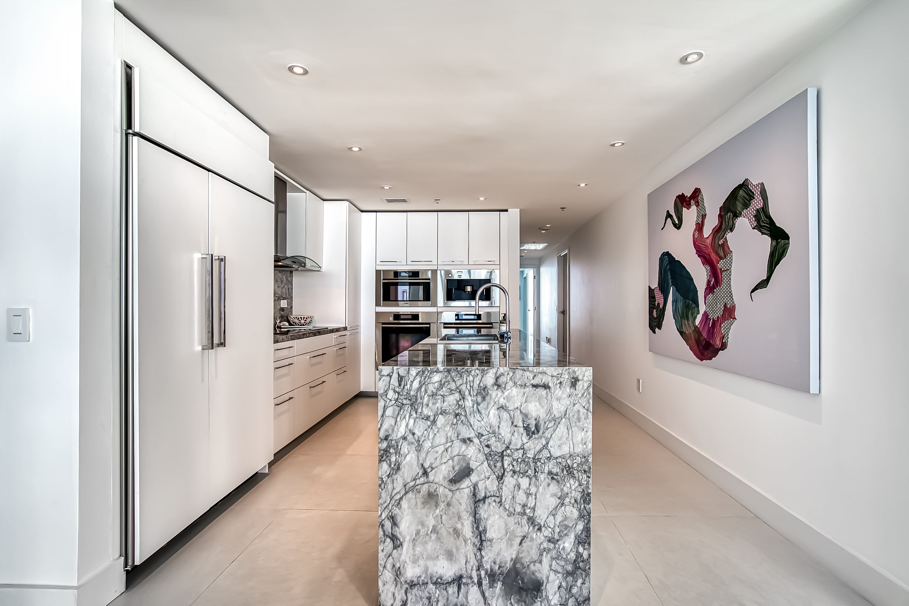 Poggenpohl White Modern Kitchen with Waterfall Island, Marble Countertops and Miele Appliances