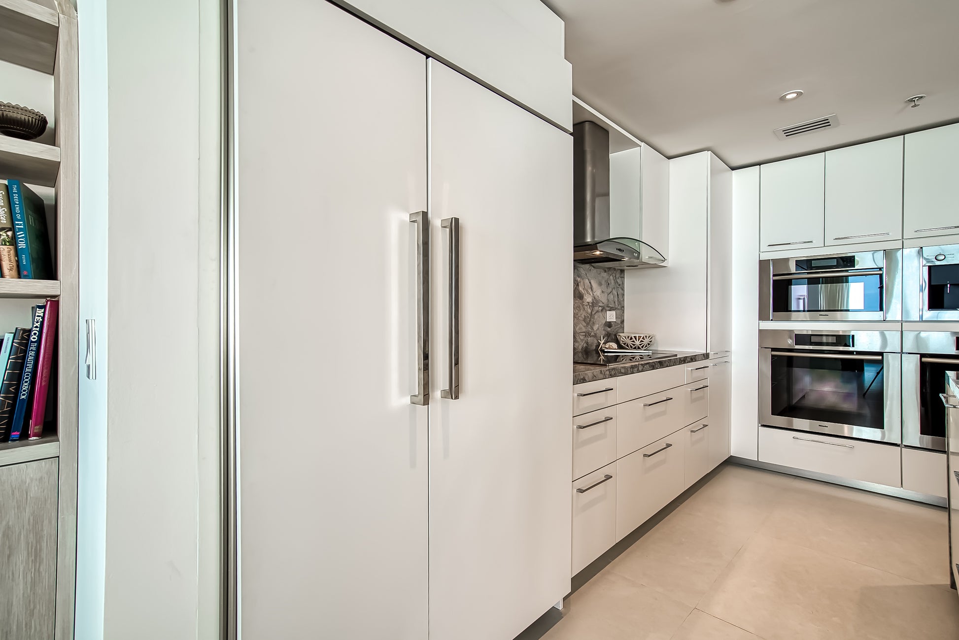 Poggenpohl White Modern Kitchen with Waterfall Island, Marble Countertops and Miele Appliances