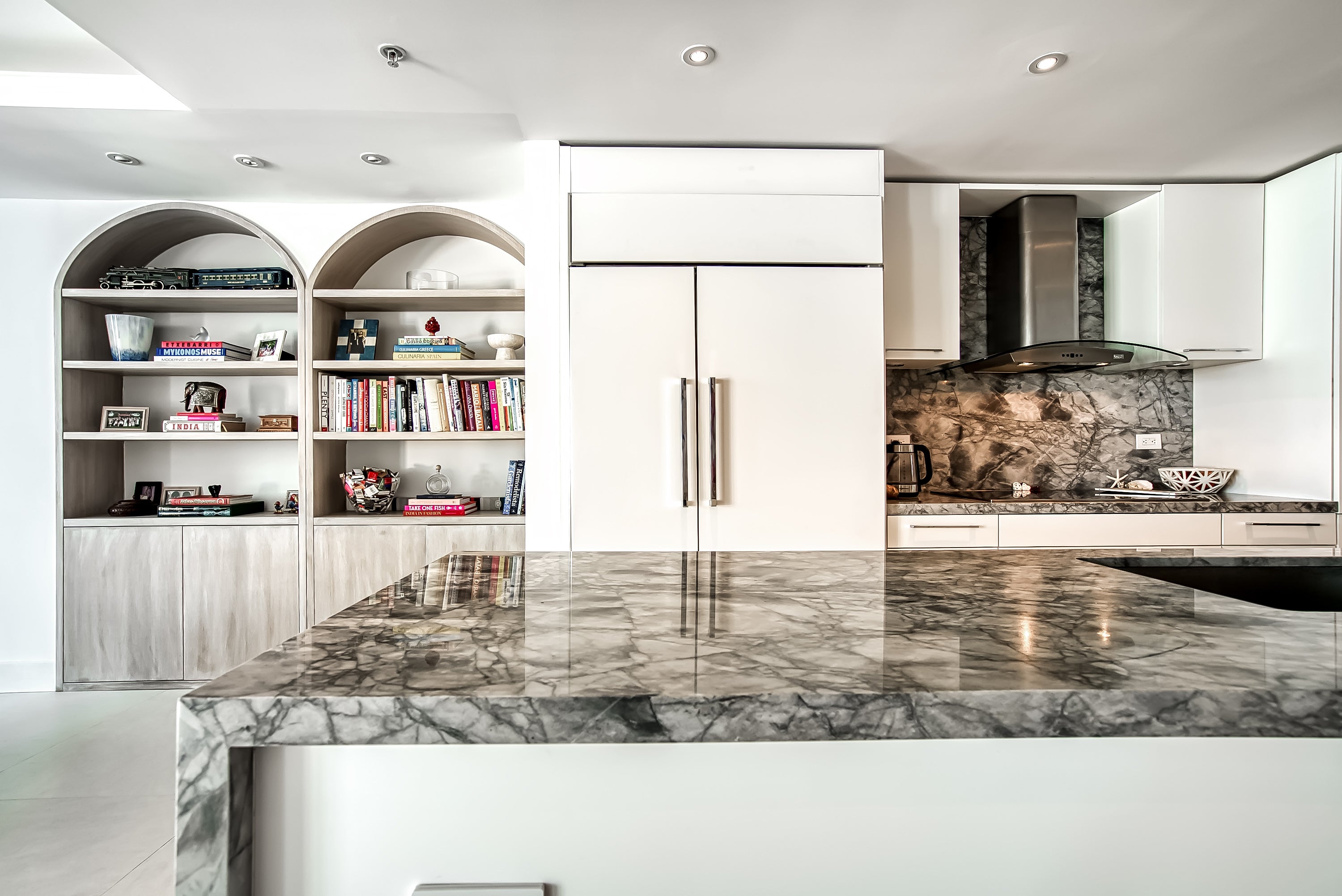 Poggenpohl White Modern Kitchen with Waterfall Island, Marble Countertops and Miele Appliances