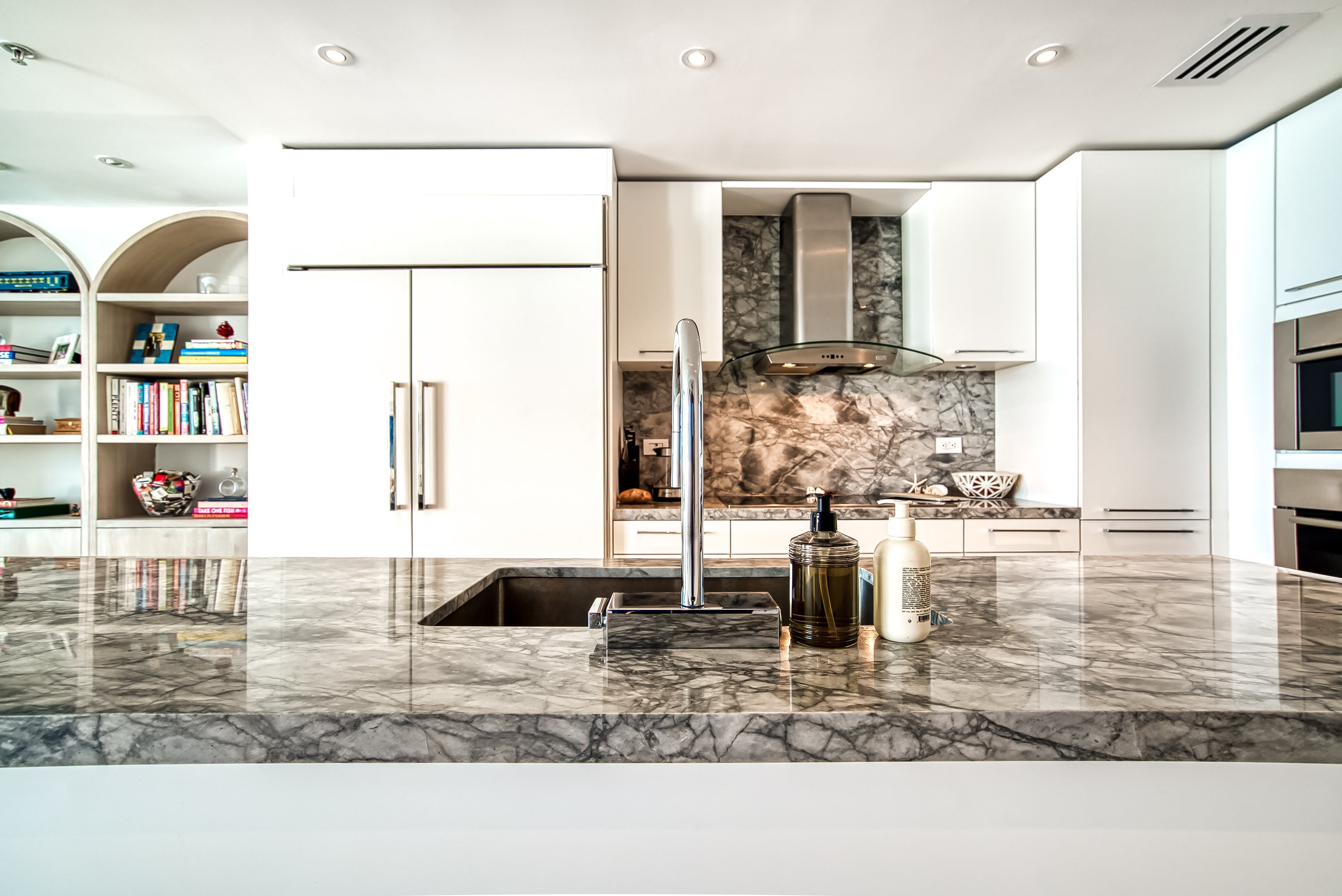 Poggenpohl White Modern Kitchen with Waterfall Island, Marble Countertops and Miele Appliances