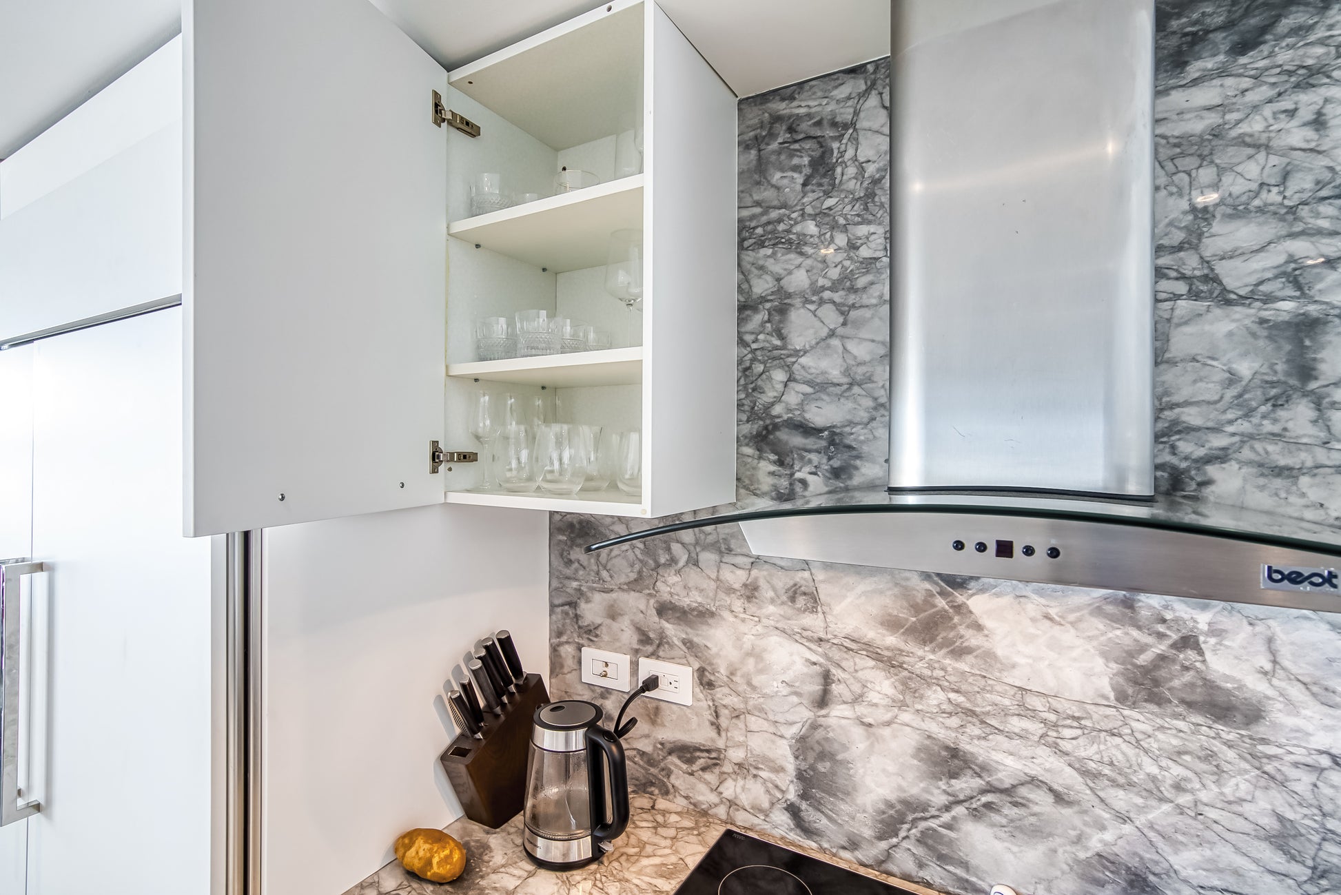 Poggenpohl White Modern Kitchen with Waterfall Island, Marble Countertops and Miele Appliances