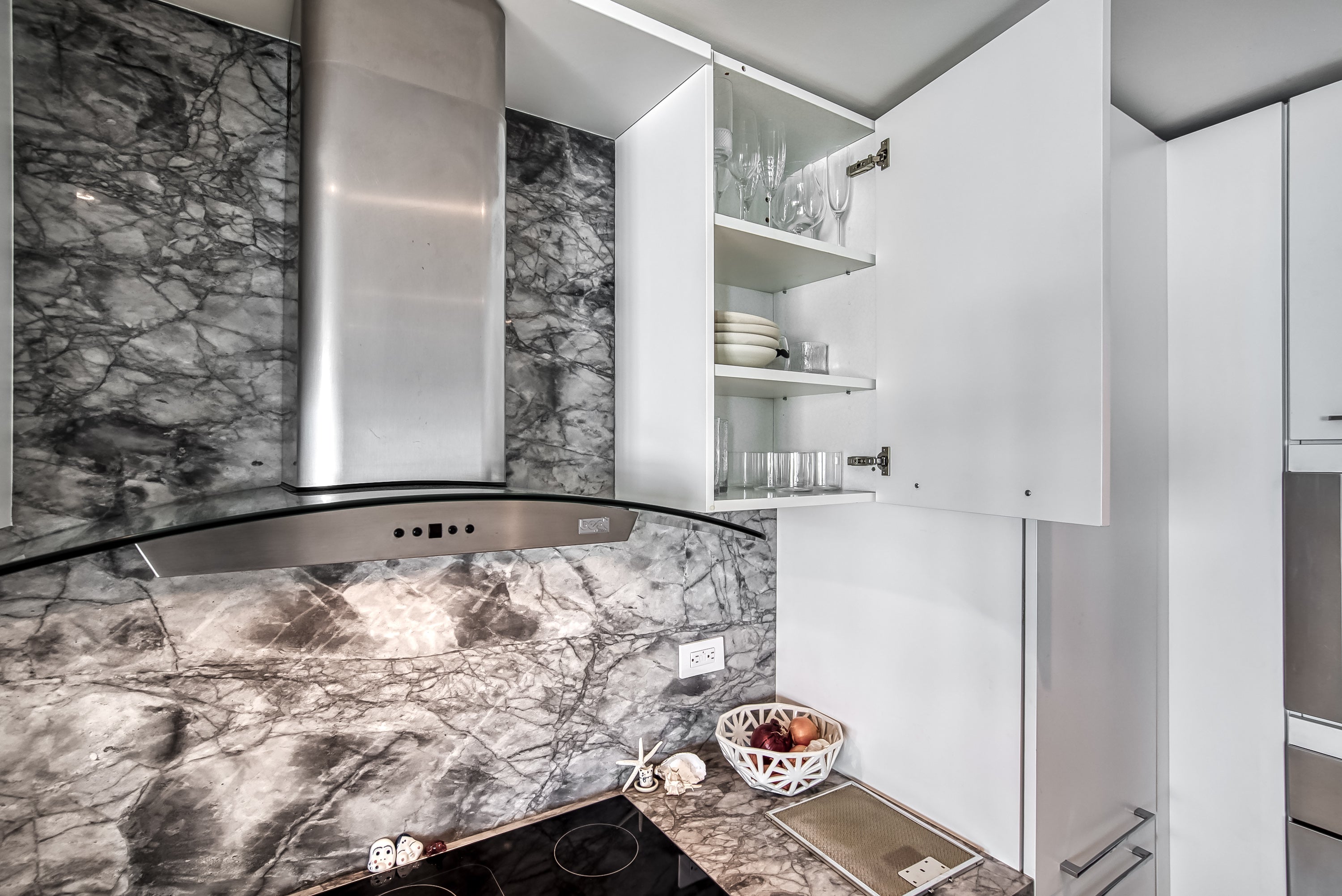 Poggenpohl White Modern Kitchen with Waterfall Island, Marble Countertops and Miele Appliances