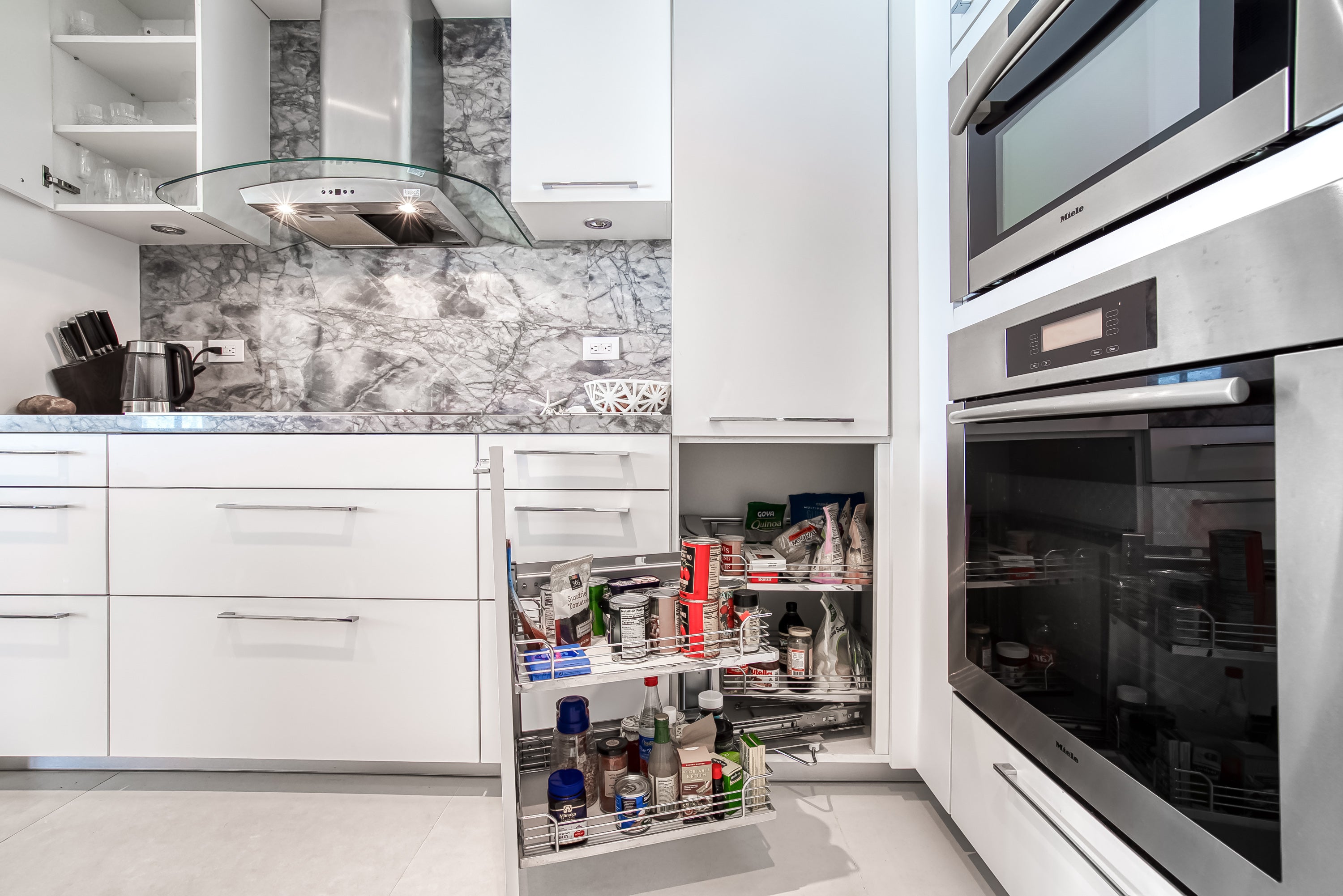 Poggenpohl White Modern Kitchen with Waterfall Island, Marble Countertops and Miele Appliances