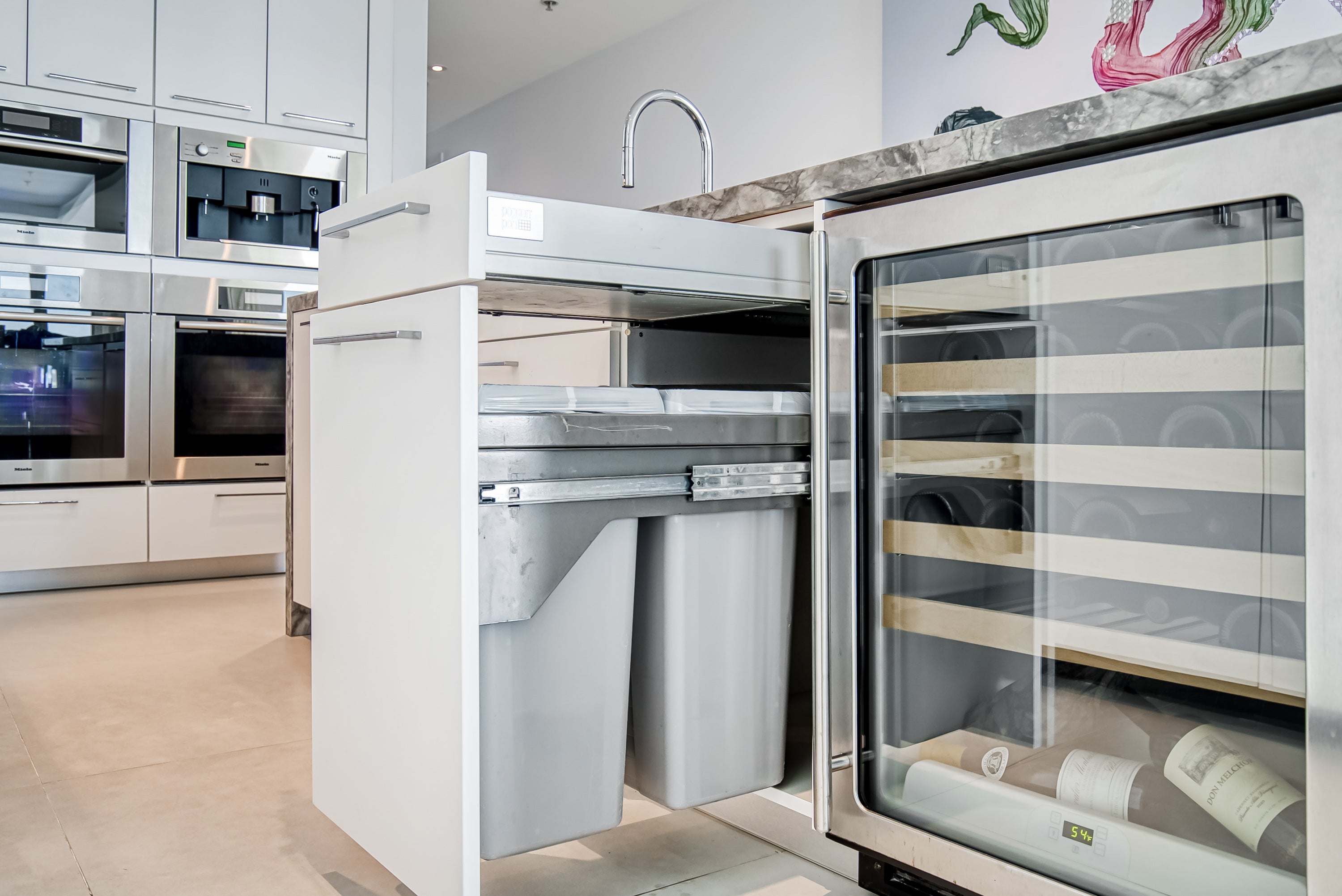 Poggenpohl White Modern Kitchen with Waterfall Island, Marble Countertops and Miele Appliances