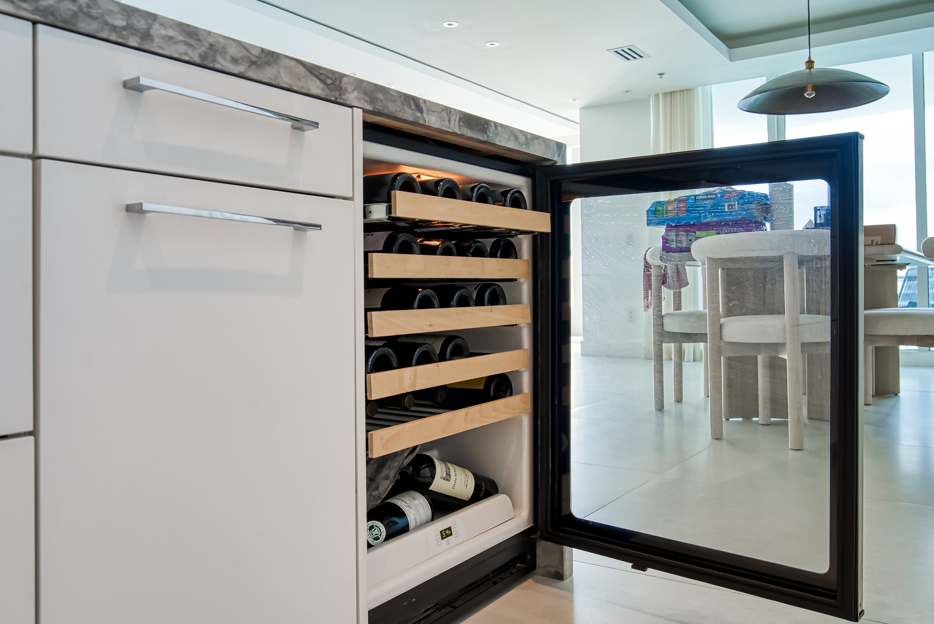 Poggenpohl White Modern Kitchen with Waterfall Island, Marble Countertops and Miele Appliances