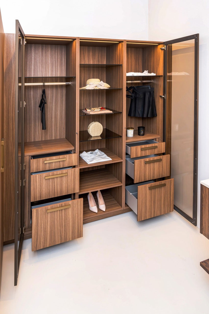 German engineered modern wardrobe closet doors open showing internal hanging rods and shelves