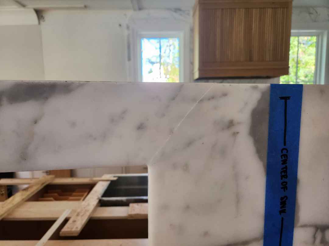 Custom Transitional White Kitchen with Natural Wood Toned Island, White Marble Countertops and 48" Wolf Range