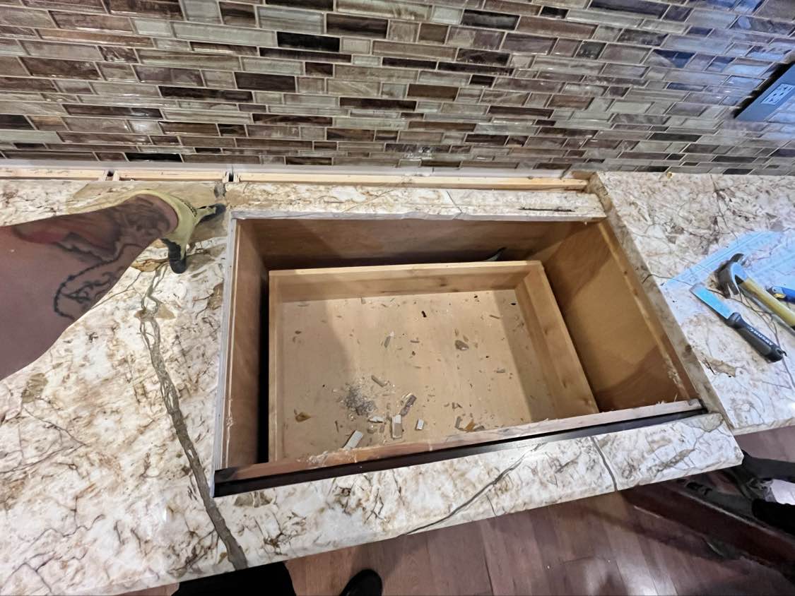 Kraftmaid Transitional Dark Wooden Kitchen with Marble Countertops and GE Monogram Appliances