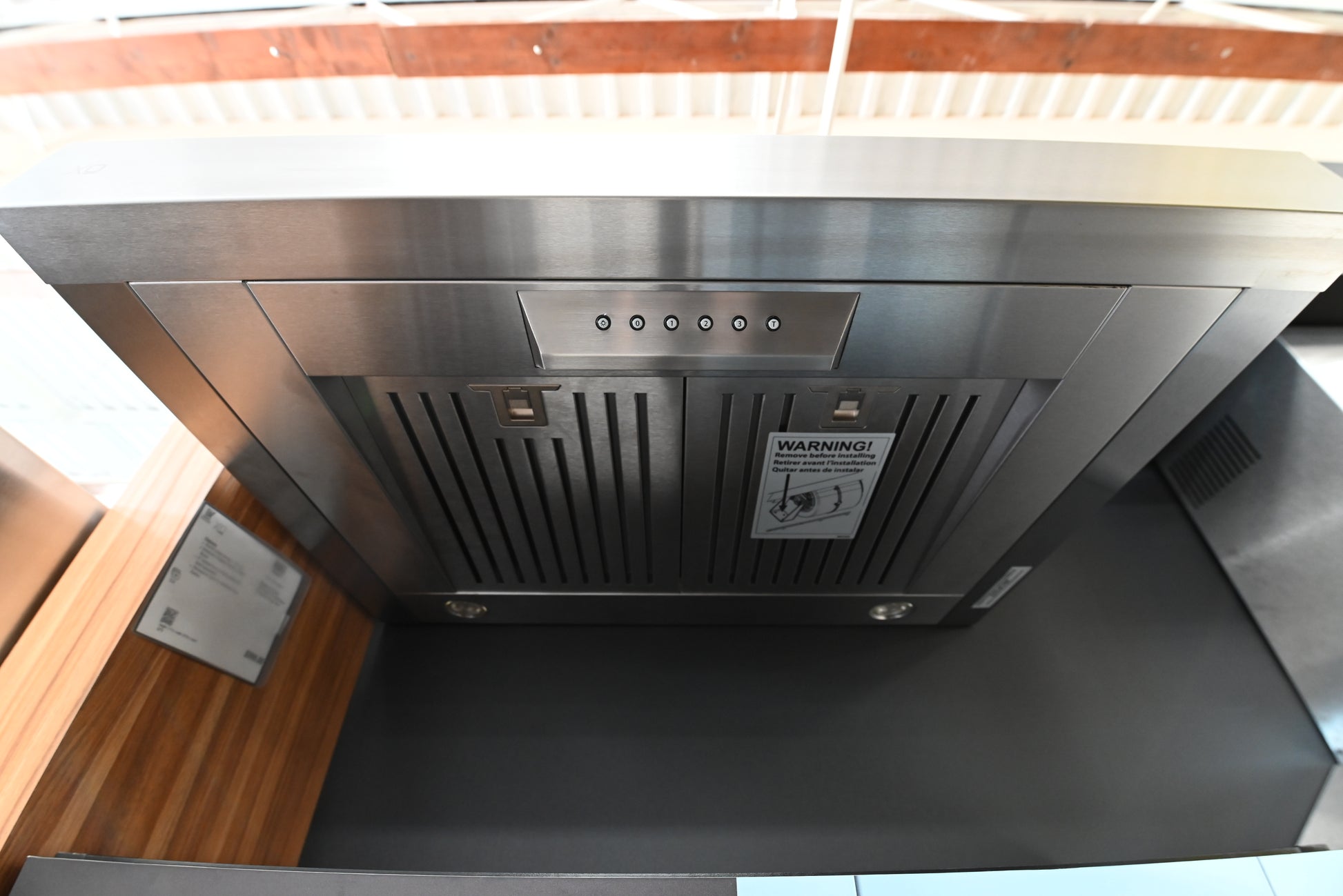 Close up of slide out visor and aluminum mesh filters on XO 30 inch range hood