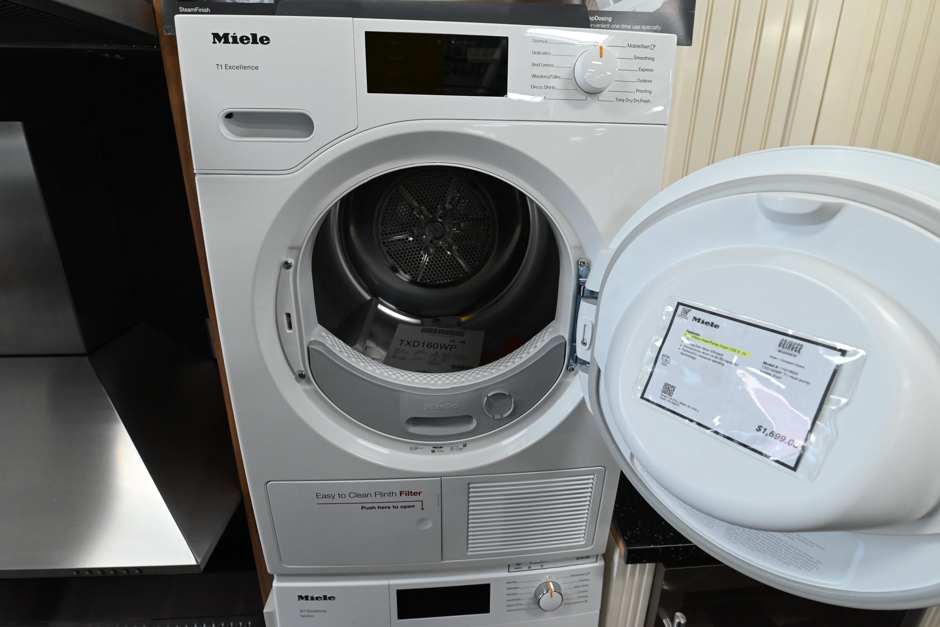 Luxury German engineered heat pump dryer showing open door internal honeycomb drum and lint filter