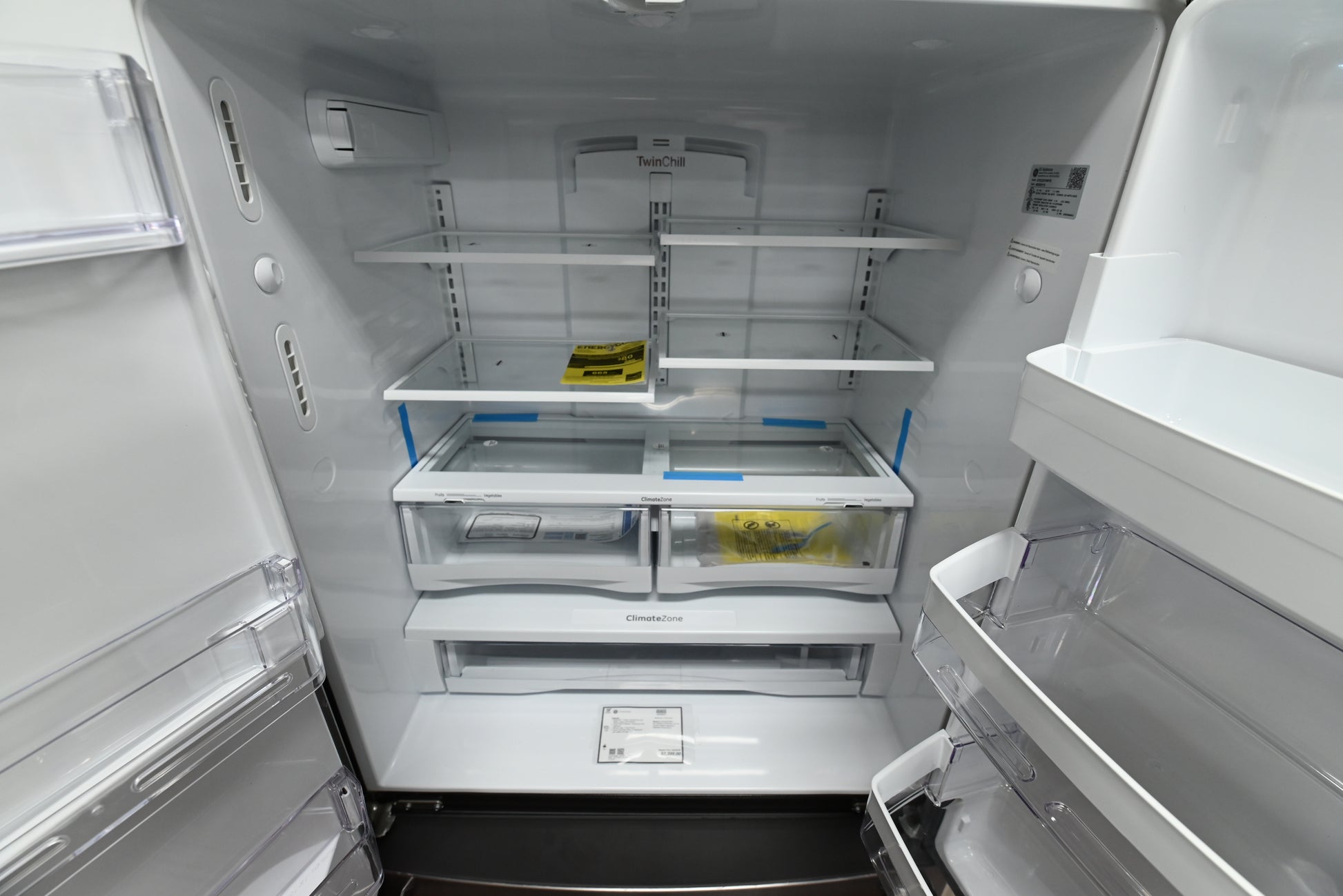 Interior view of the open fresh food shelves and LED lighting inside the GE GYE22GYNFS counter-depth refrigerator