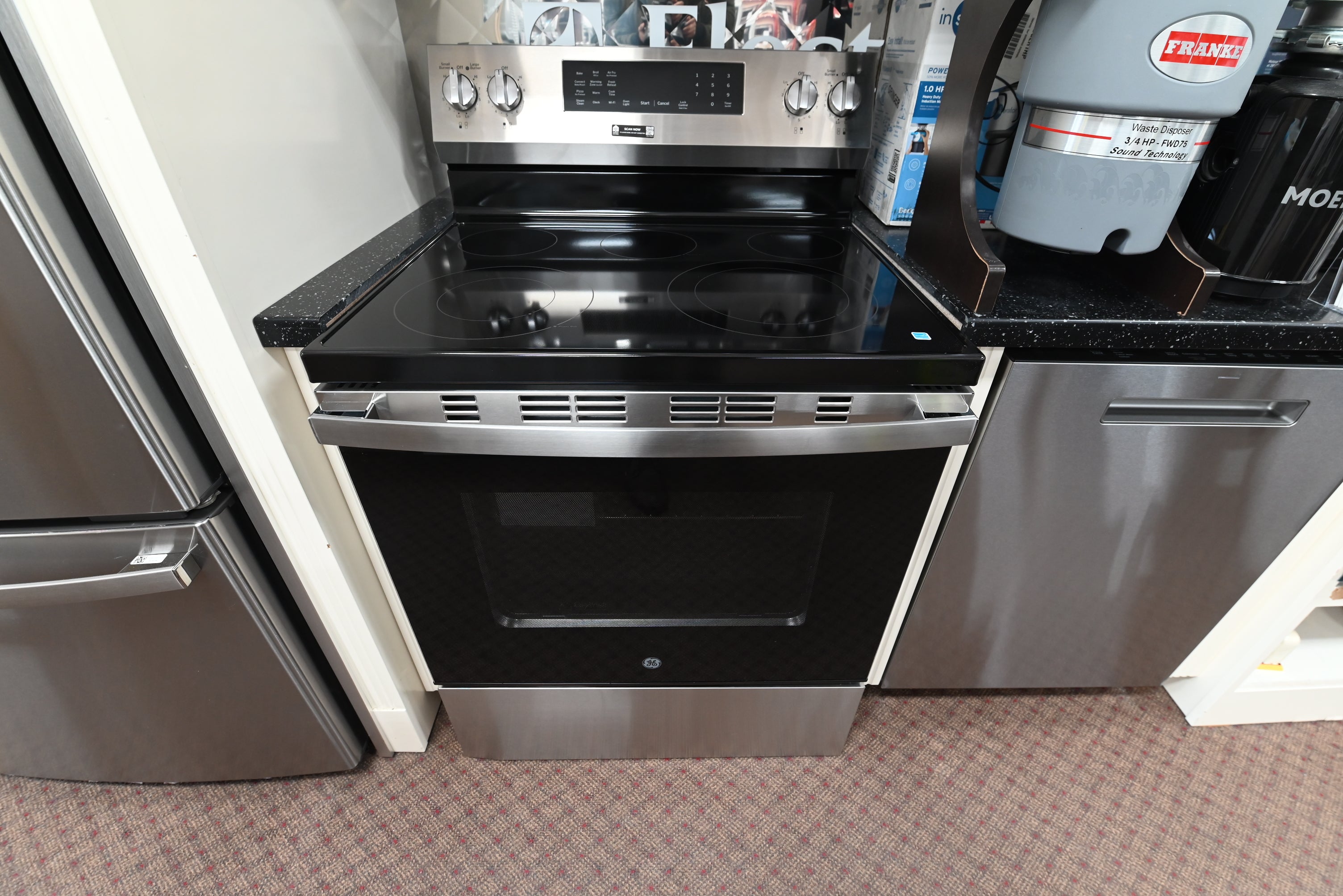 GE GRF600AVSS 30 inch freestanding electric range in stainless steel with front glass oven window and a rear control console