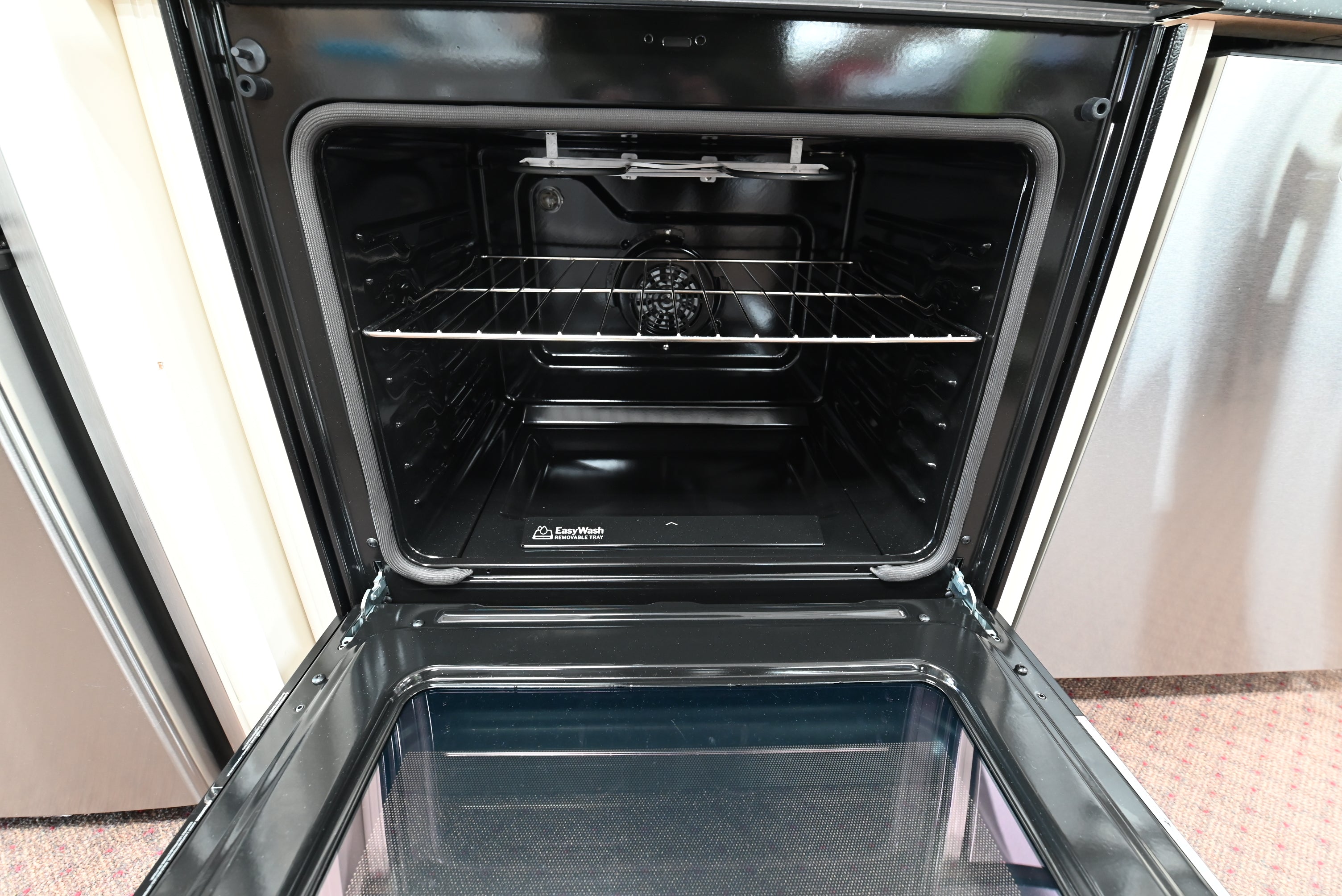 Interior view of the 5.3 cubic foot oven cavity showing the removable EasyWash tray lining the bottom of the GE GRF600AVSS range