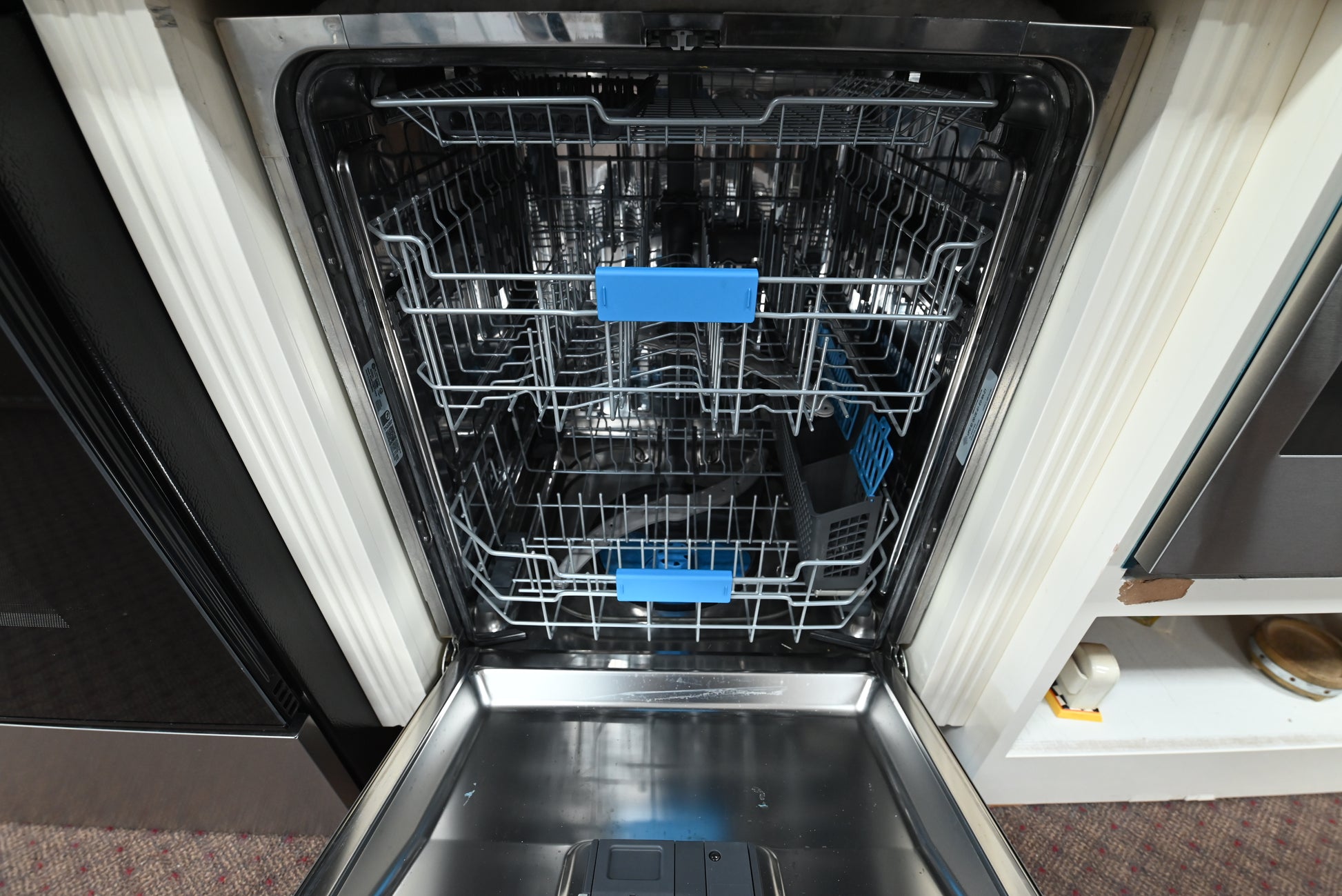 Interior view of the premium stainless steel tub, spray arms, and nylon racks of the GE Profile PDP715SYVFS dishwasher