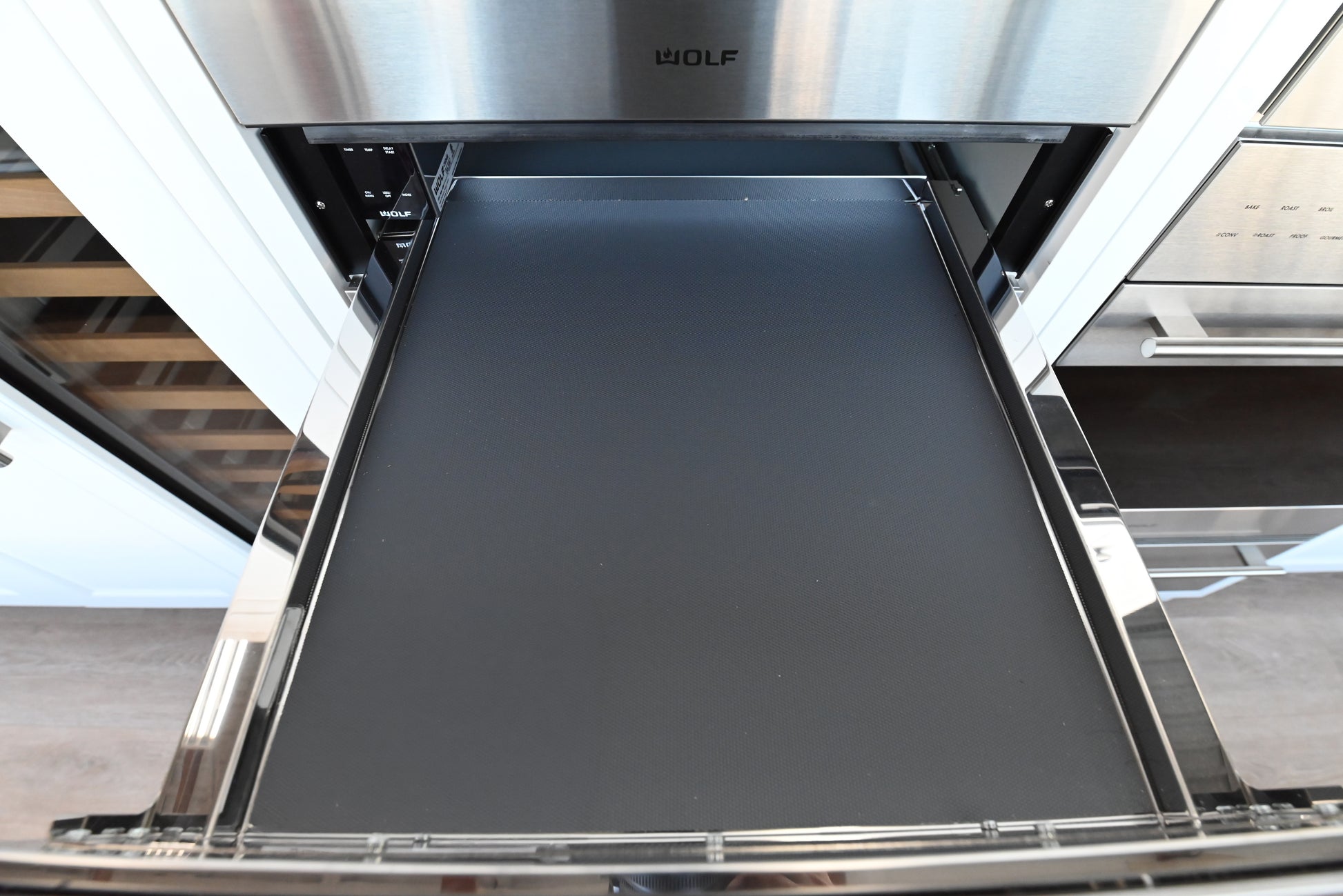 Luxury 24 inch built in cup warmer drawer by Wolf integrated below a coffee system