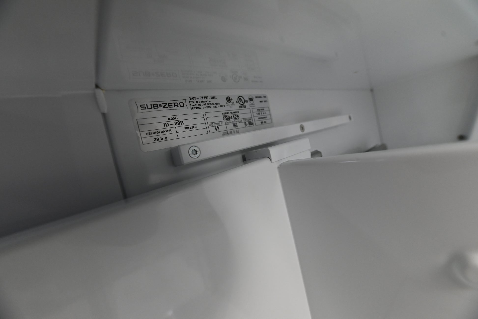 Sub Zero refrigerator drawers open showing interior dividers and soft on LED lighting
