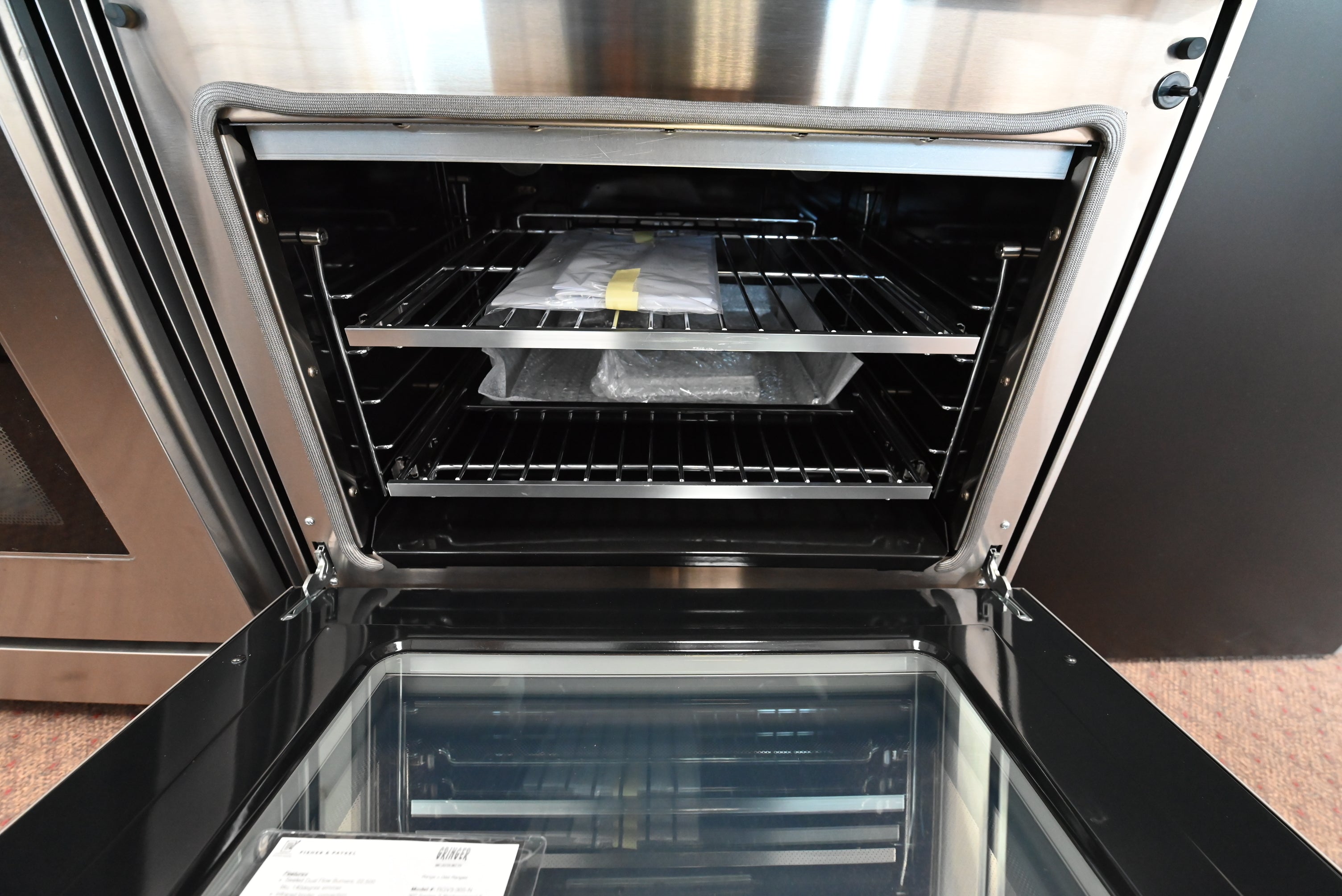 Close up of Fisher & Paykel RGV3305N control panel and stainless burner knobs