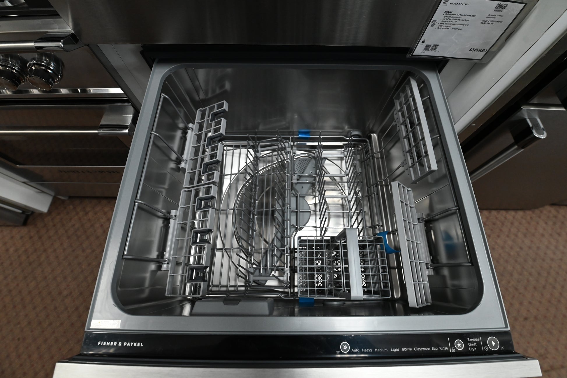 Open upper drawer view of the Fisher Paykel Double DishDrawer showing tall glass clearance and flexible racking