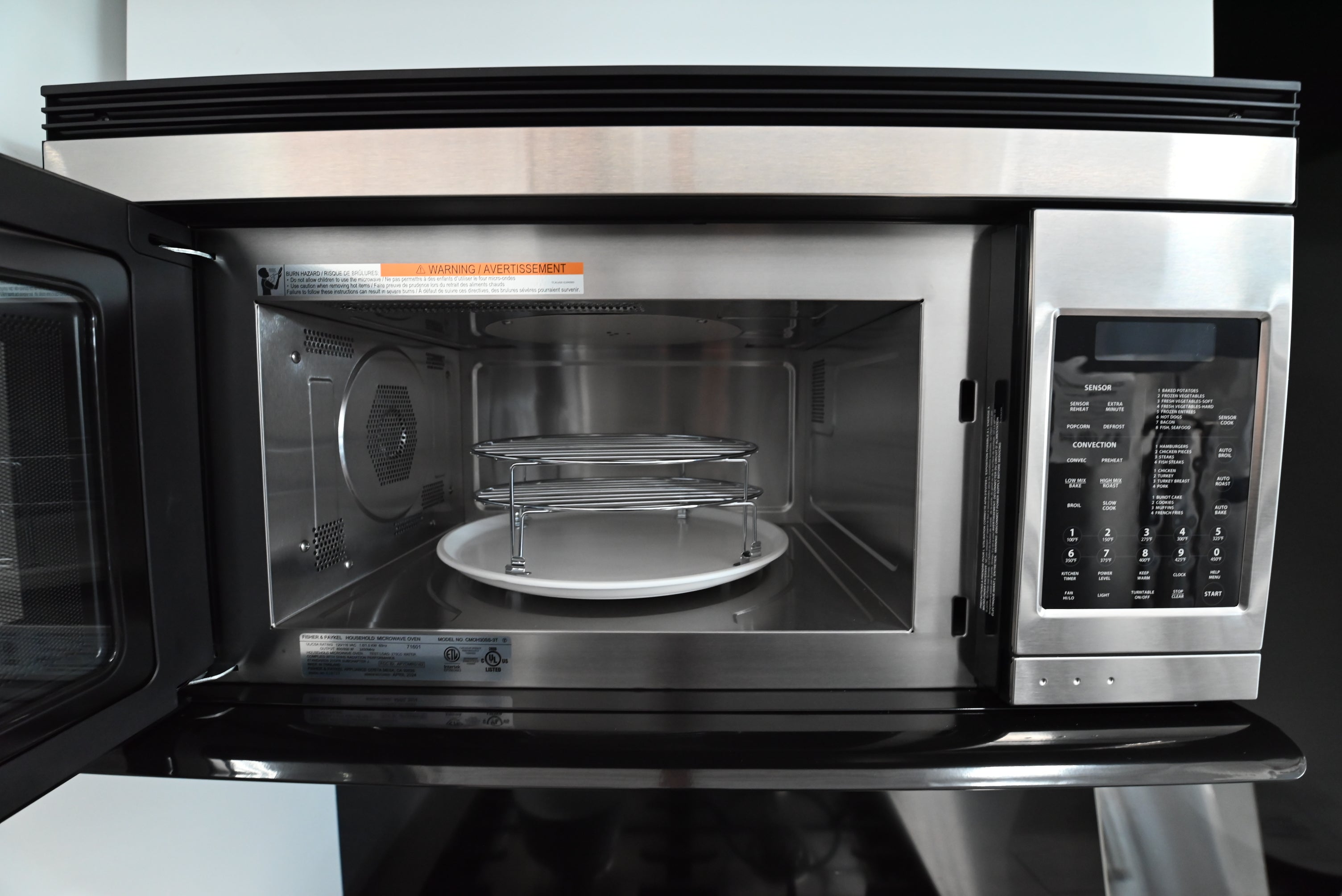 Close up view of the glass touch control panel and digital clock on the Fisher Paykel microwave