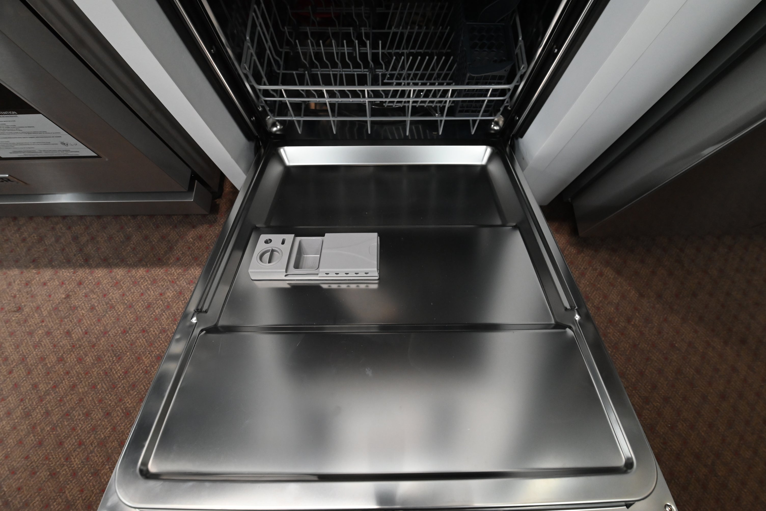 Thor 24 inch dishwasher open showing full stainless steel tub and adjustable racks
