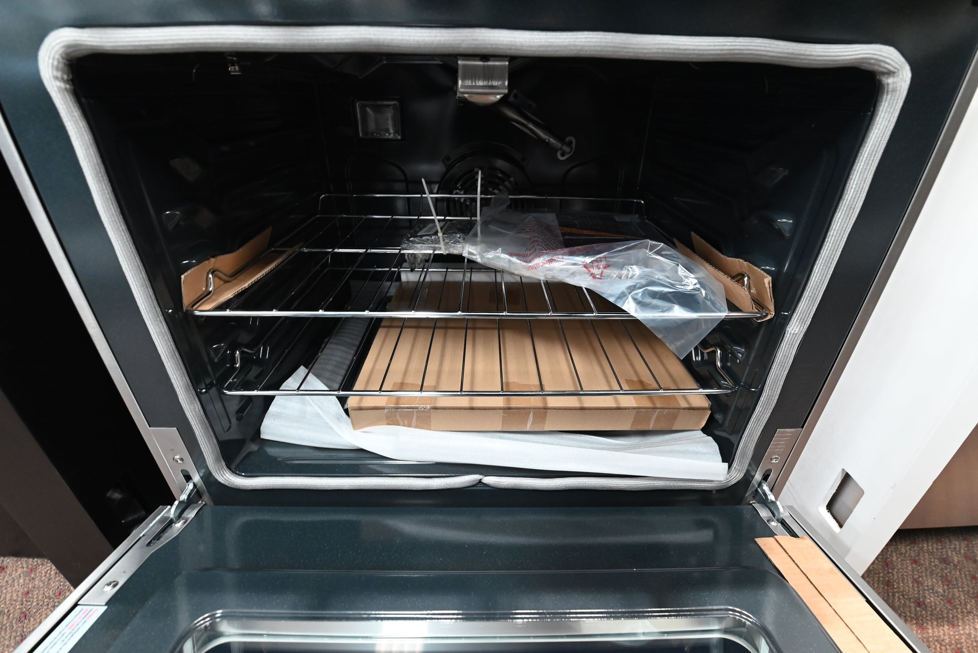 Thor 30 inch range open showing gray porcelain oven interior and lower storage