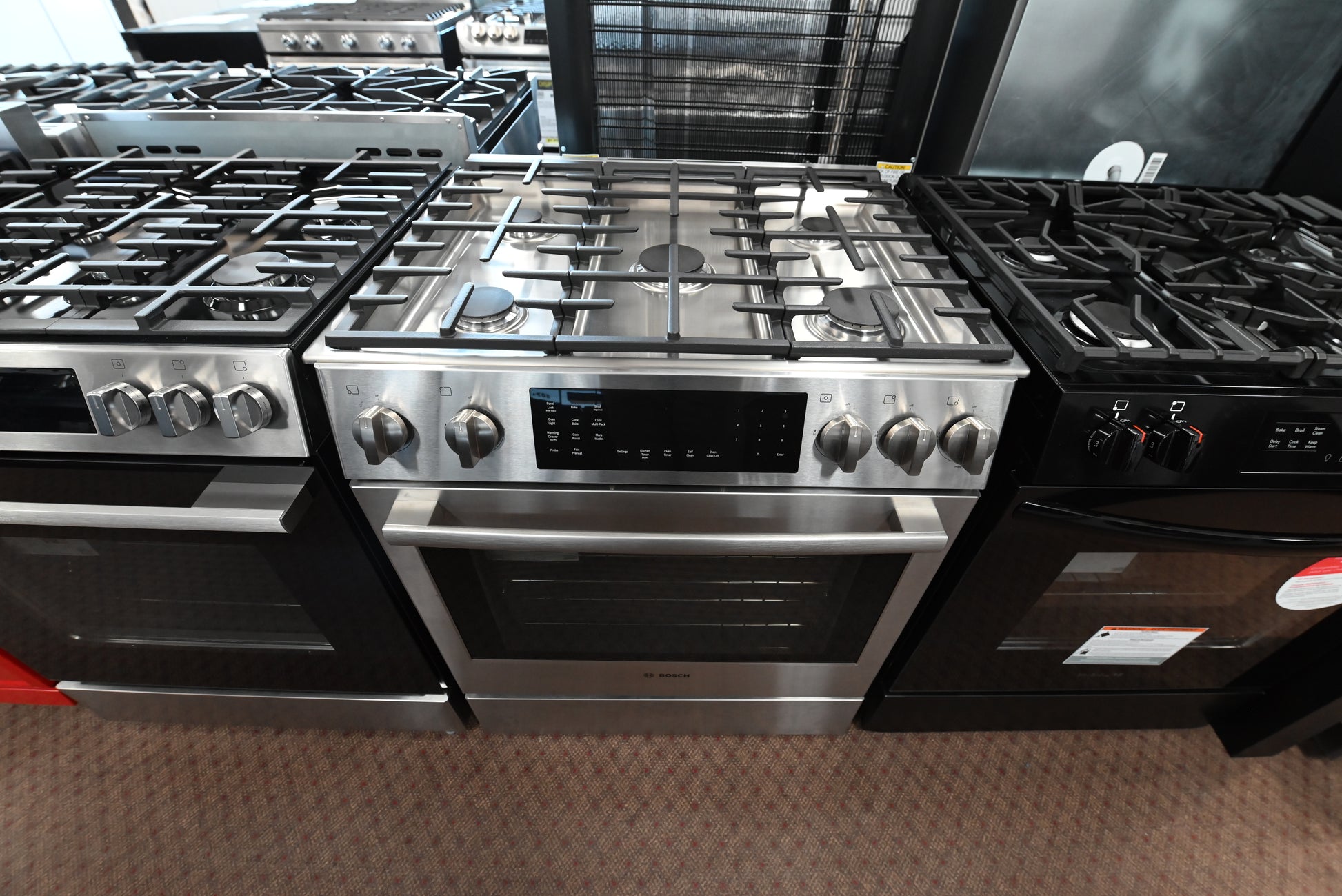 Luxury 30 inch integrated dual fuel range open showing oven interior racks and meat probe