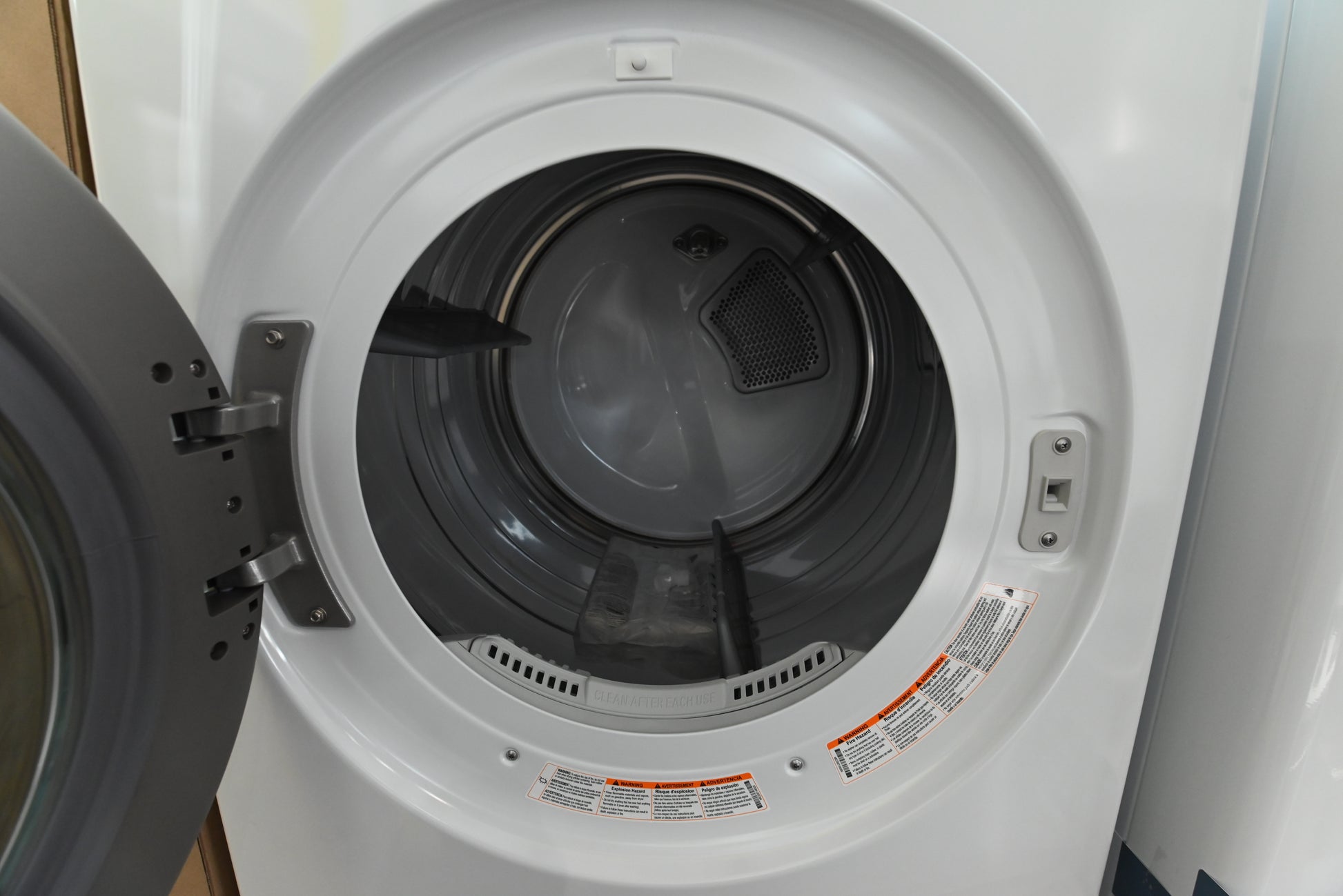 Luxury 27 inch vertical laundry tower showing centered electronic control panel between washer and dryer