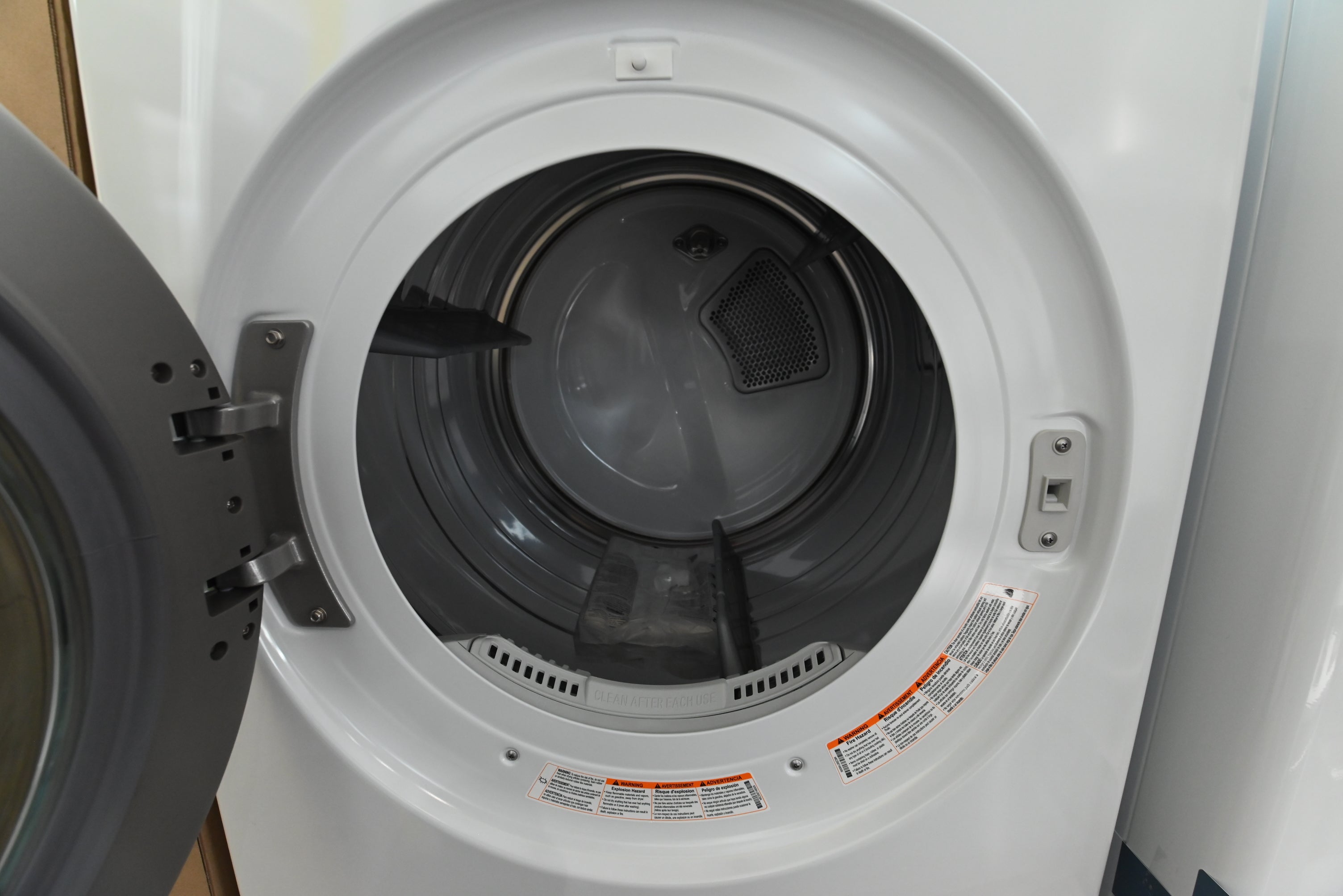 Luxury 27 inch vertical laundry tower showing centered electronic control panel between washer and dryer