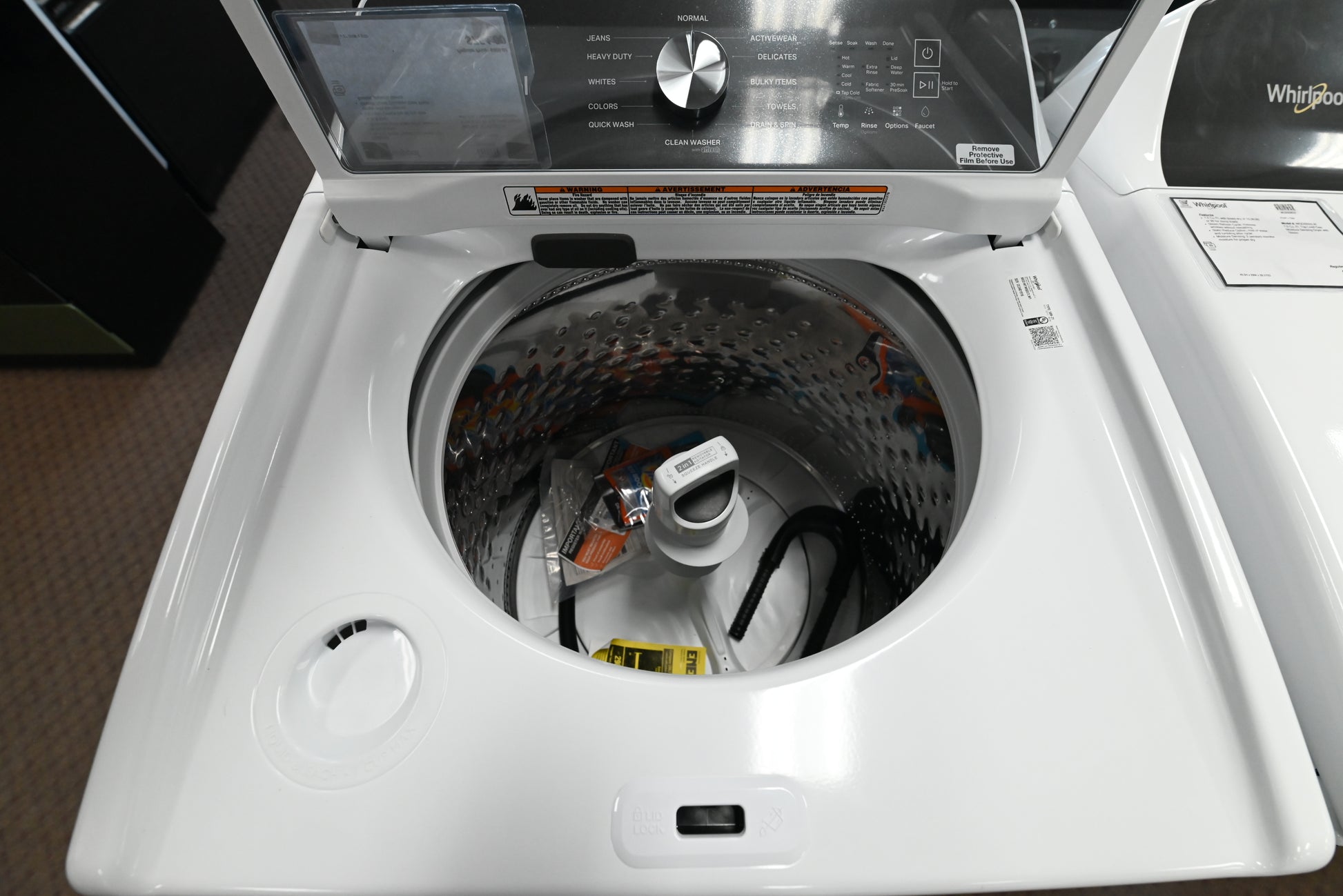 Detail view of the control dial and built in water faucet button on the Whirlpool washer
