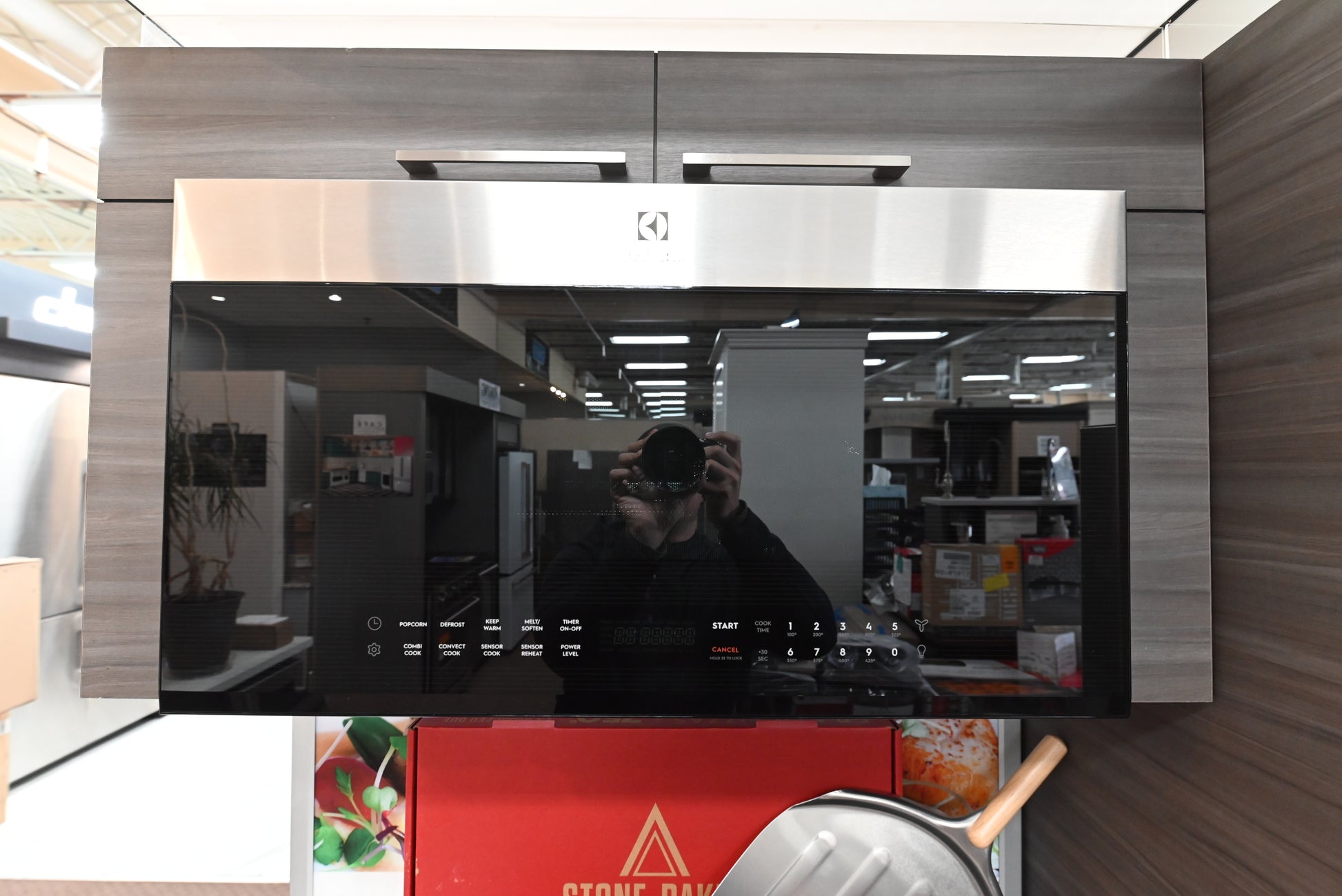 Electrolux EMOW1911AS 30 inch over the range microwave front view showing sleek dark glass door and stainless steel trim