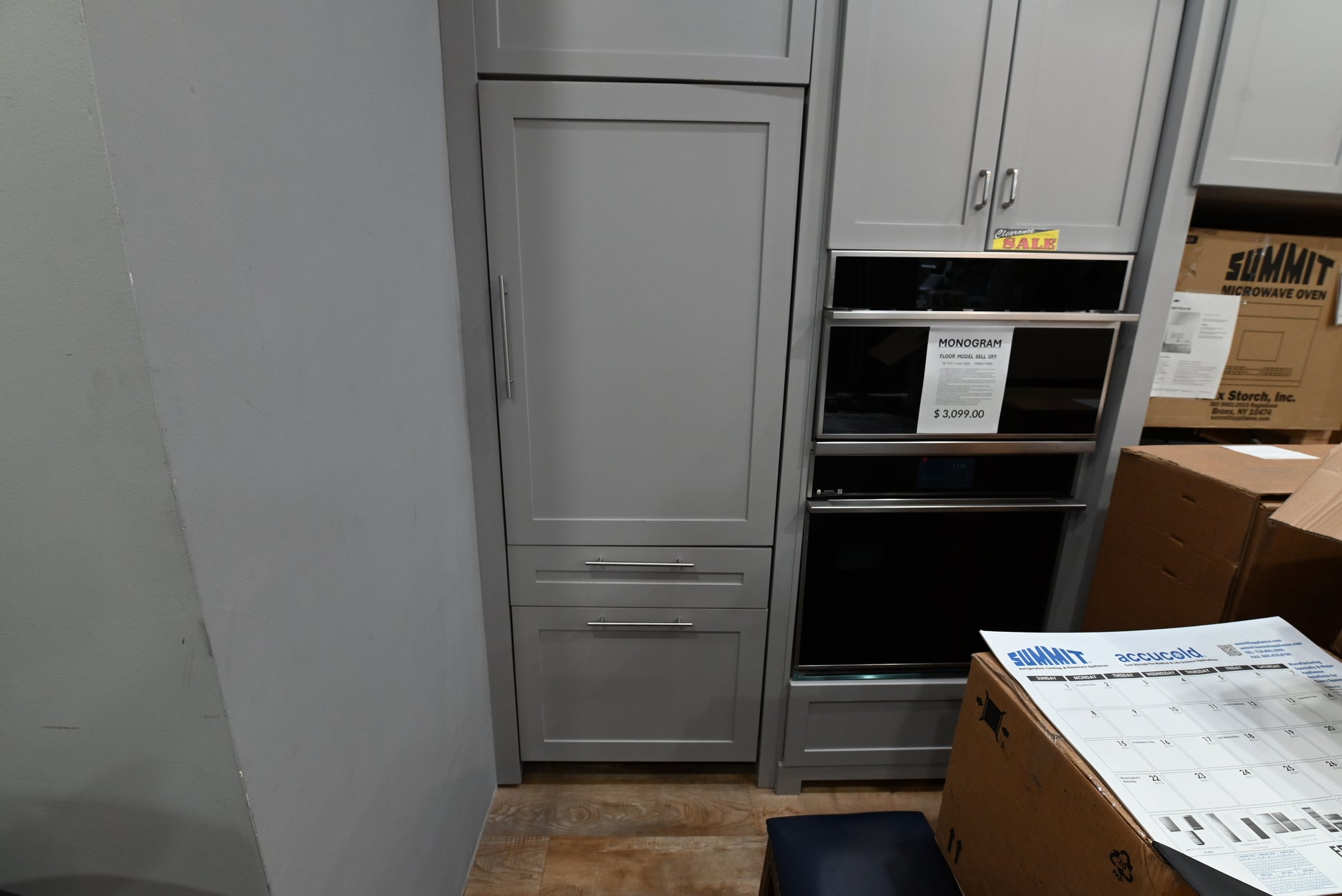 Monogram ZIC303NPPII 30 inch integrated panel ready bottom freezer refrigerator custom mounted with wood cabinet panels to match modern kitchen design