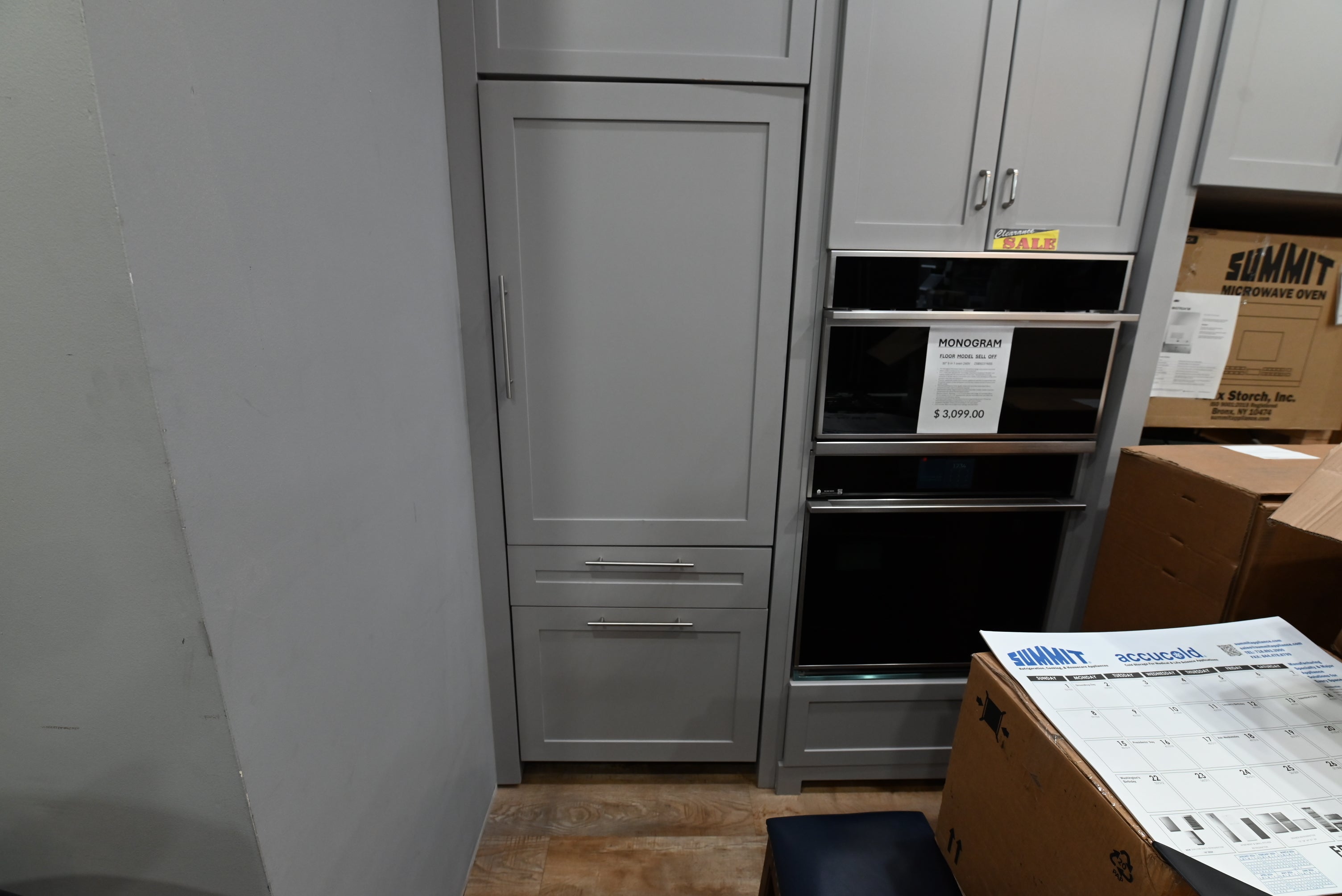 Monogram ZIC303NPPII 30 inch integrated panel ready bottom freezer refrigerator custom mounted with wood cabinet panels to match modern kitchen design