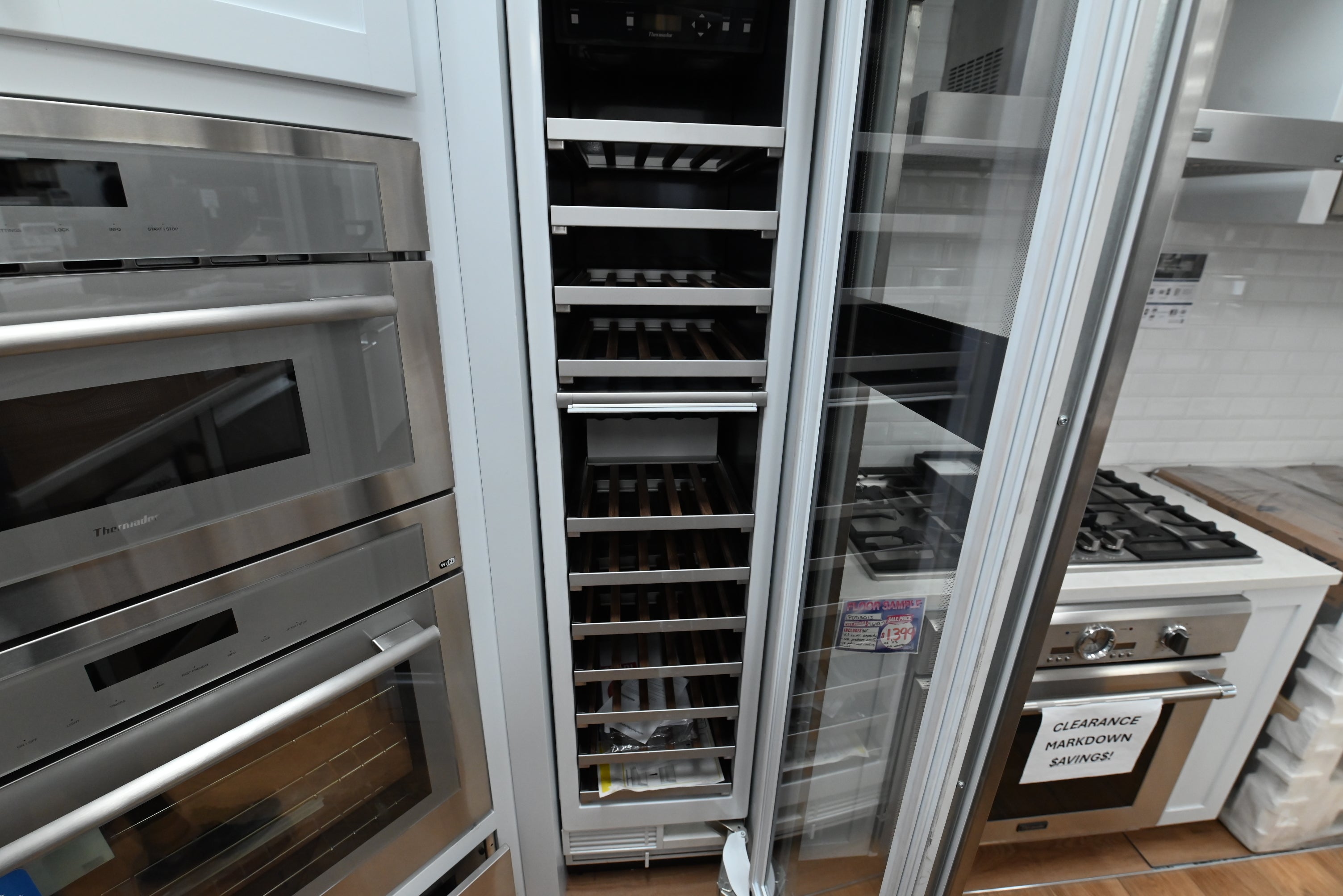 Luxury 18 inch integrated wine preservation tower open showing 70 bottle capacity and oak wood racks