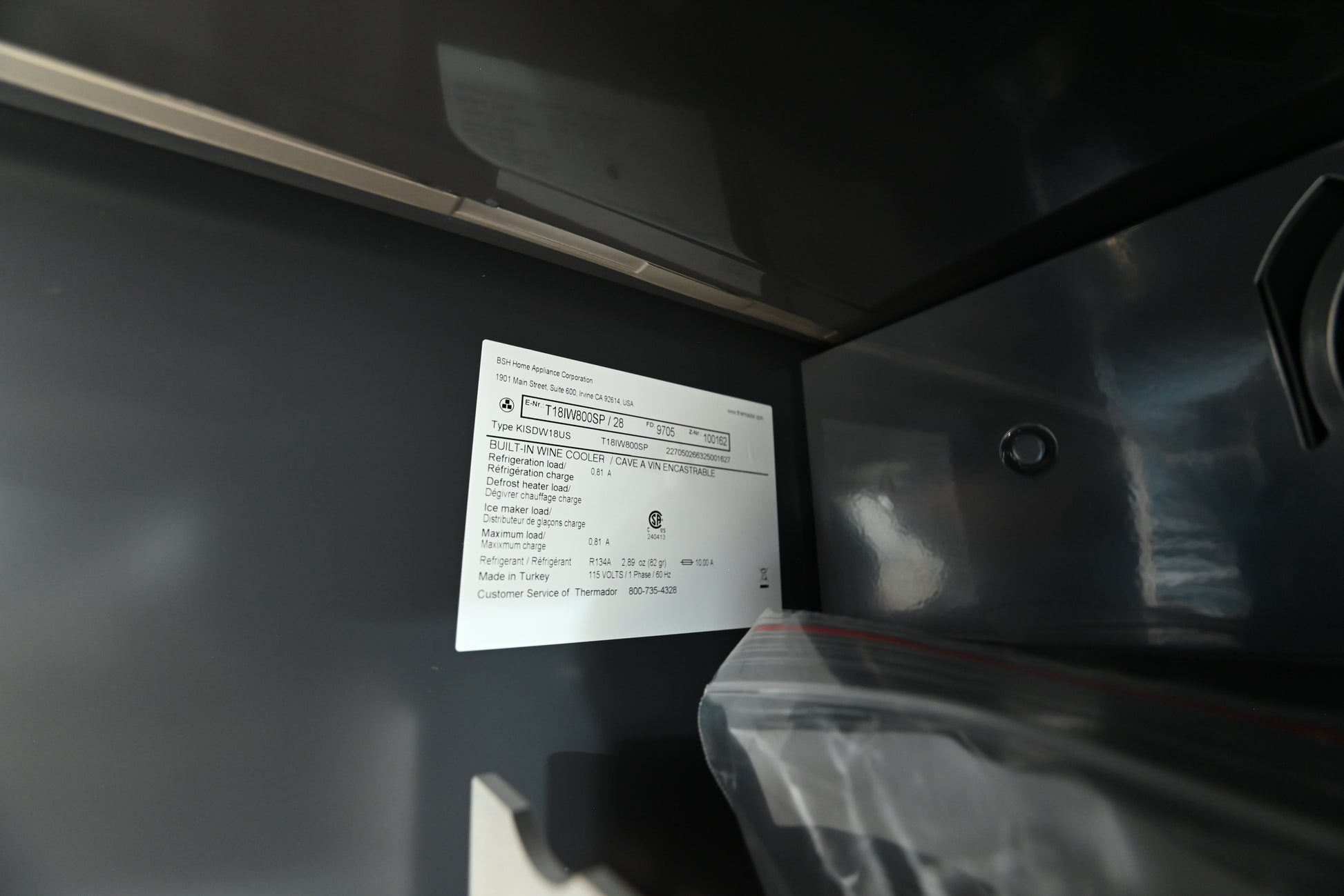 Thermador 18 stainless steel wine refrigerator showing full height glass door and Masterpiece handle
