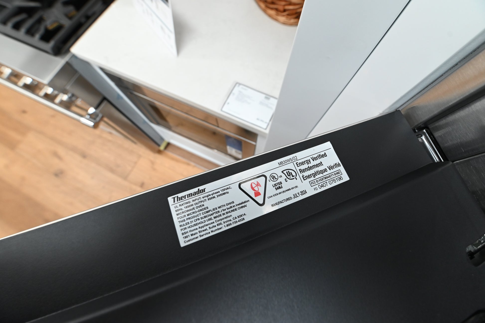Thermador 30 combination wall oven close up showing sleek control knobs and gray glass panels