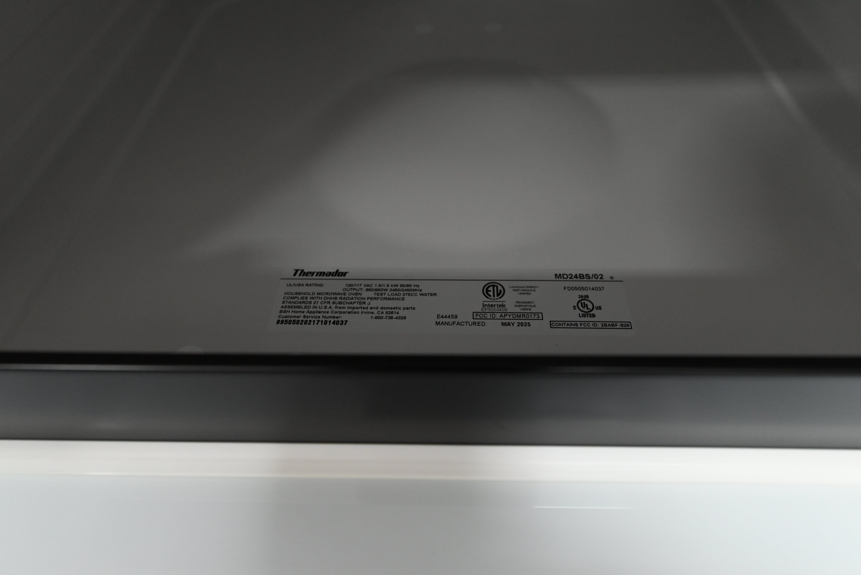 Thermador 24 microwave drawer showing tilted concealed drop down control pad panel