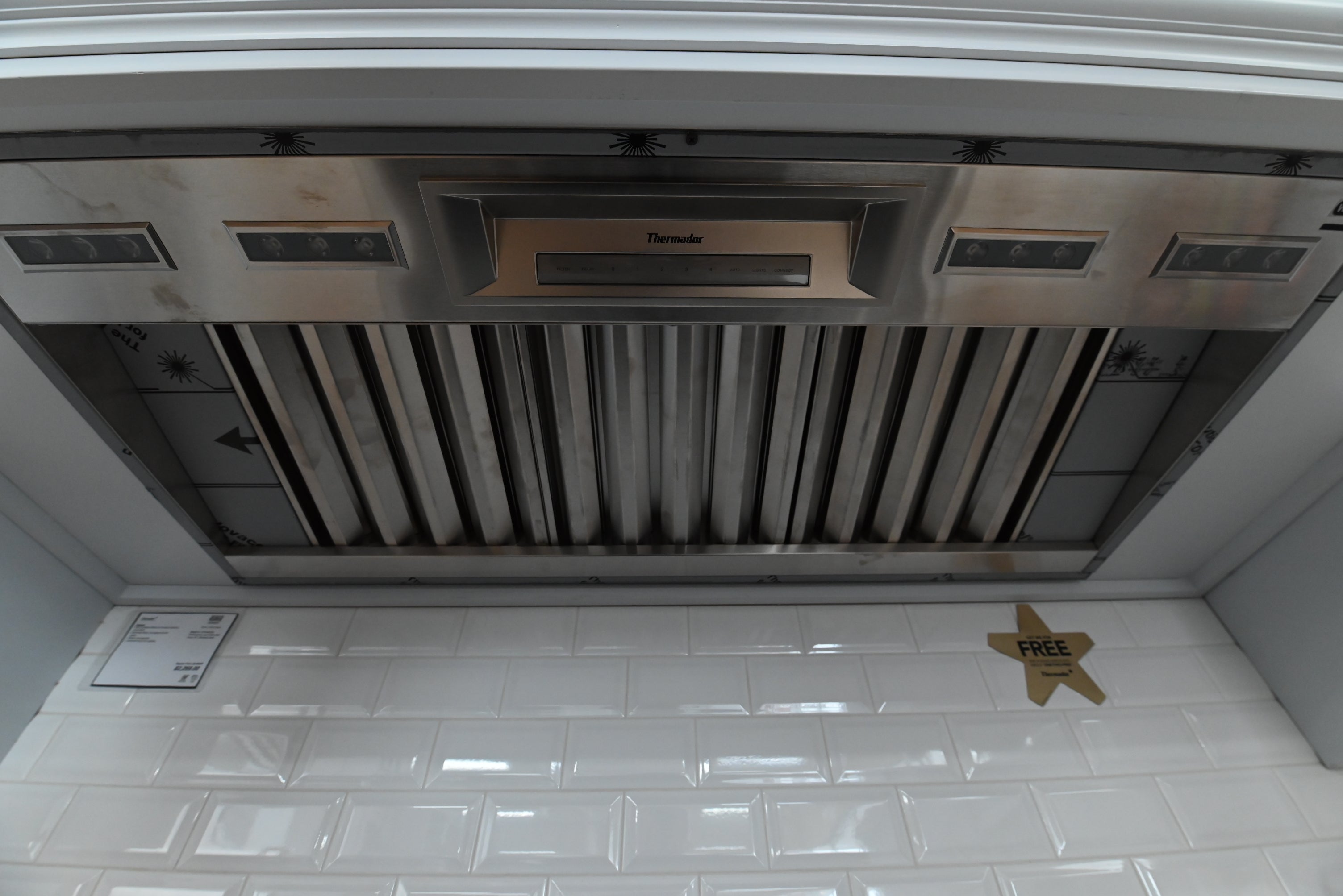 Luxury 48 inch custom cabinet hood liner looking up showing stainless steel commercial baffle filters