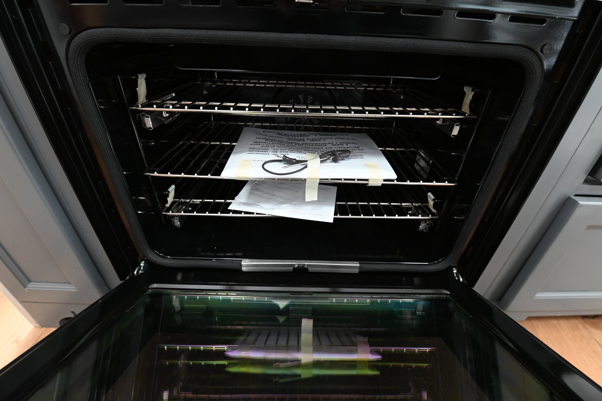 Luxury 30 inch integrated wall oven open showing blue porcelain cavity and two TruGlide extension racks