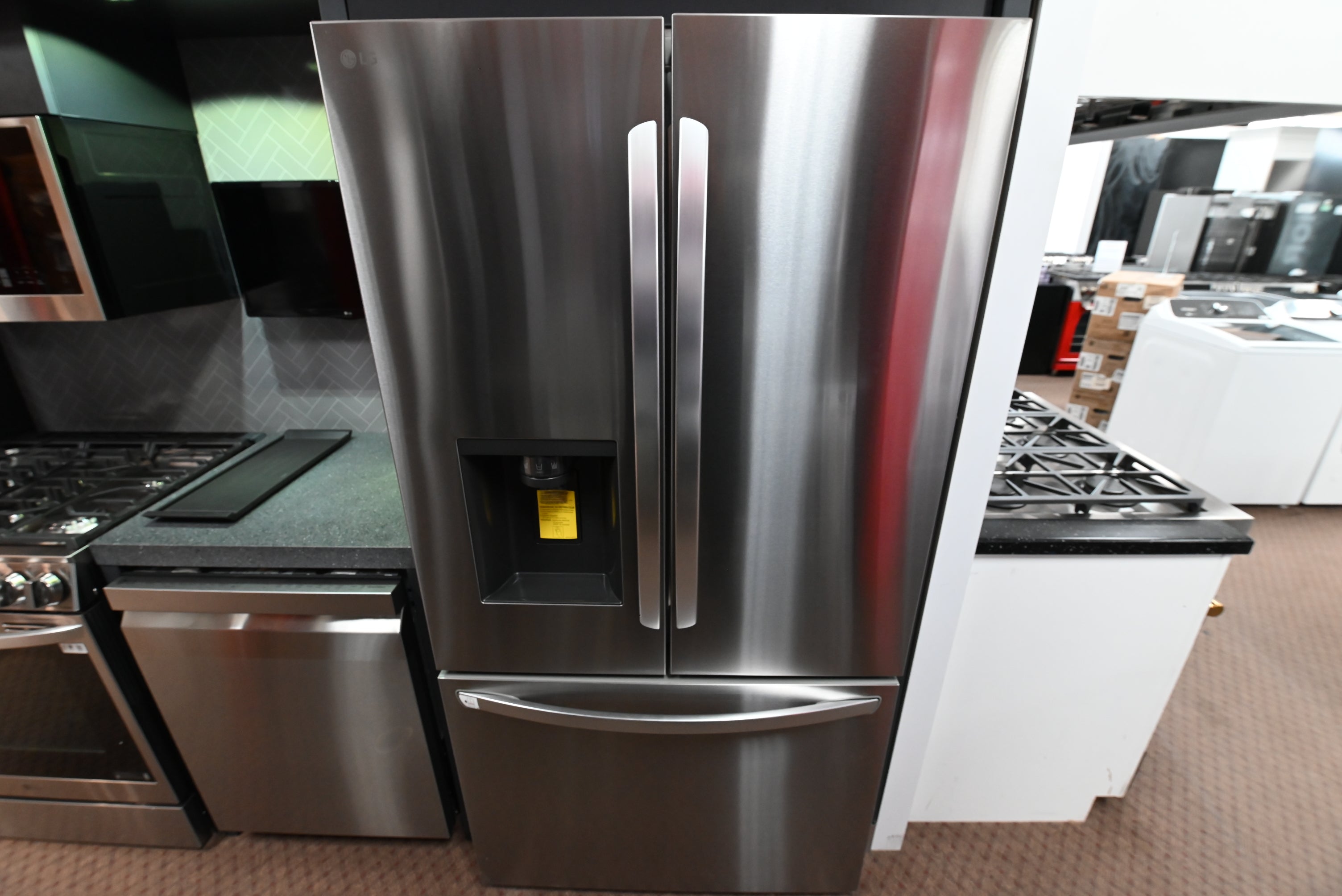 LG LRFXC2606S 26 cu ft counter depth French door refrigerator in fingerprint resistant stainless steel with a front water dispenser